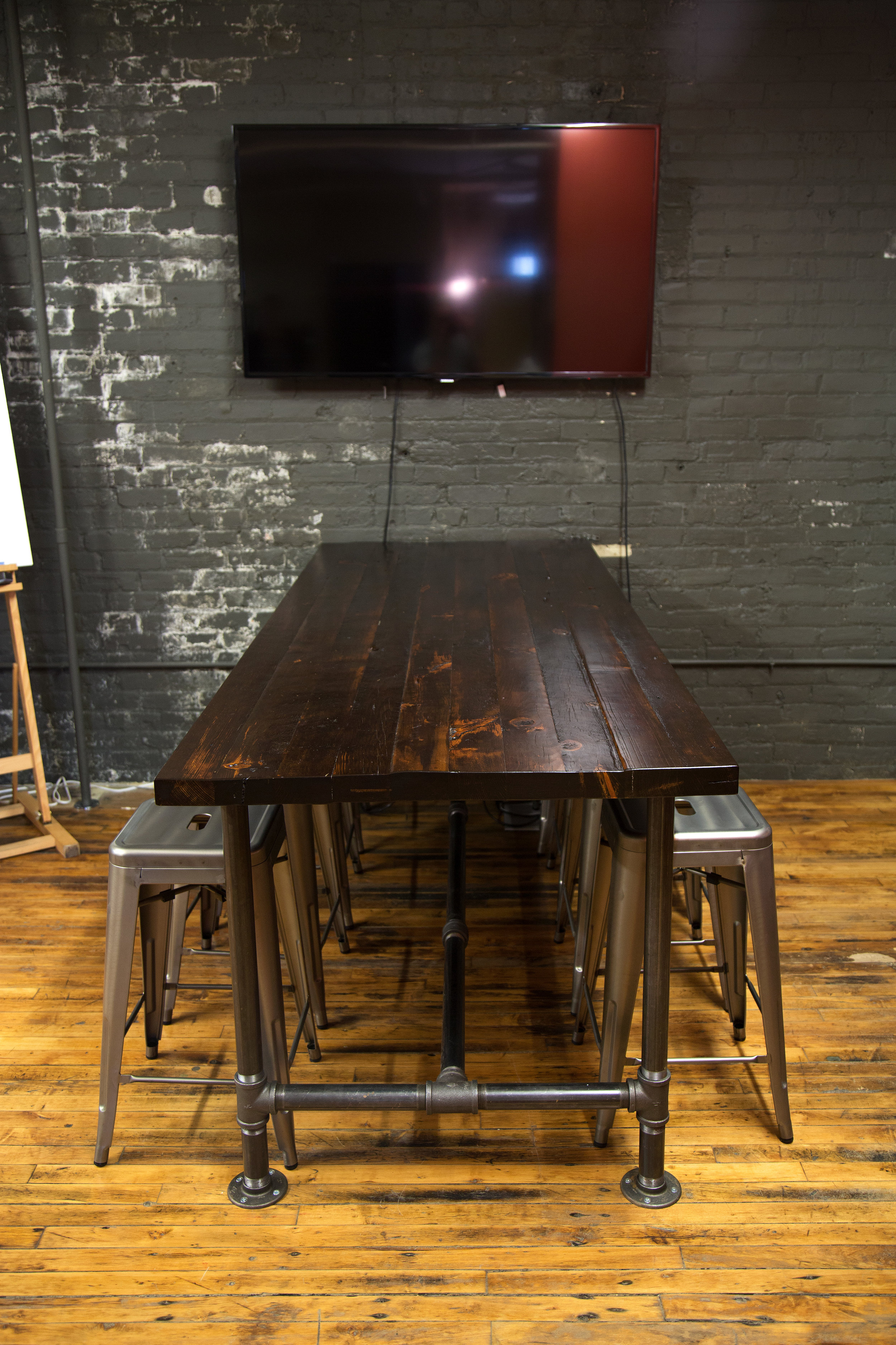 Reclaimed wood + black pipe break room table
