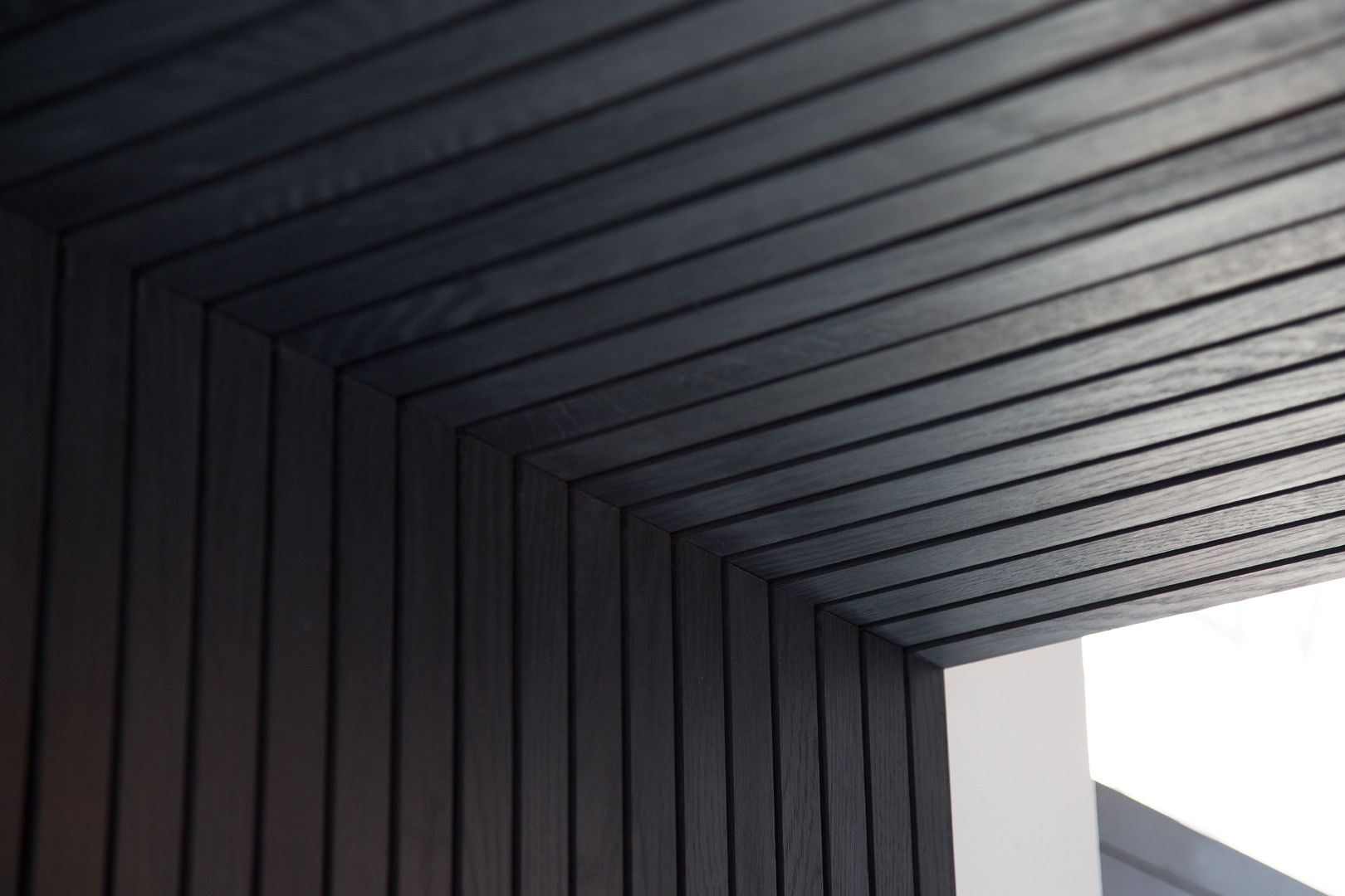 Intense black slatted soffit