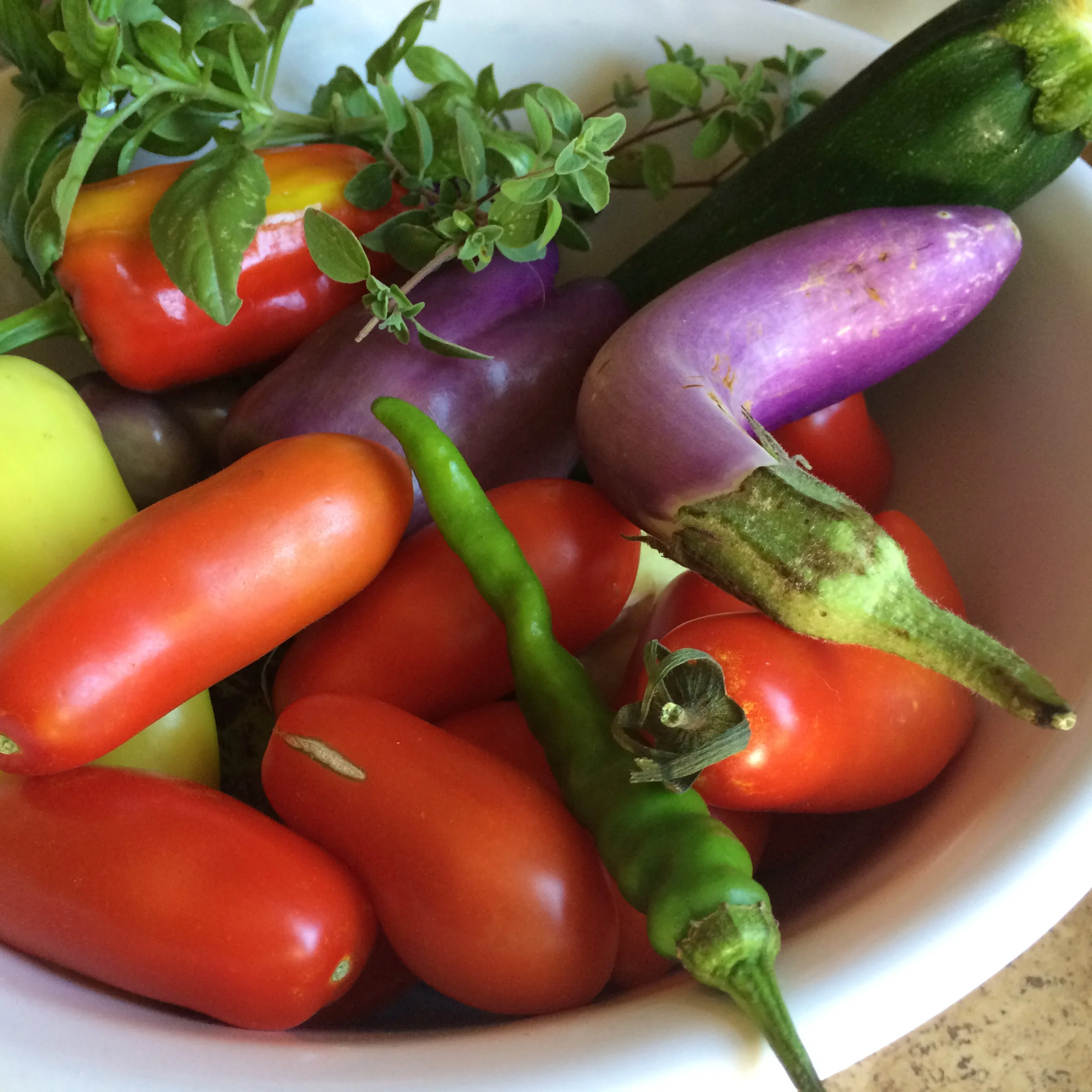 Ingredients: 2-3 eggplant, 2 zucchini, 5-6 plum tomatoes, 2-3 sweet peppers, 1 large onion, 1-2 hot chili peppers (optional), 1 clove garlic, fresh oregano, fresh basil, olive oil, salt and black pepper.