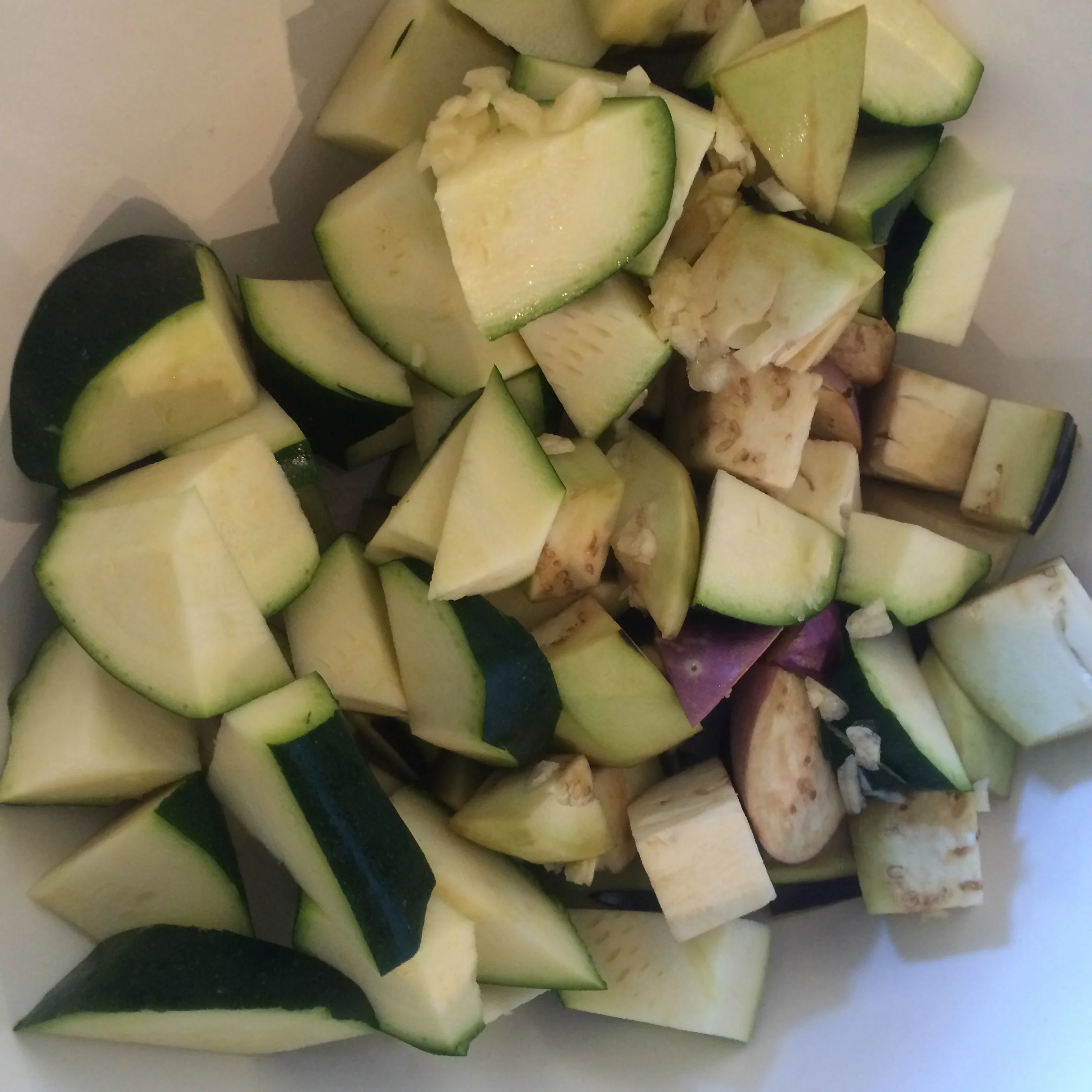 Rough chop the eggplant, zucchini and garlic clove and set aside.