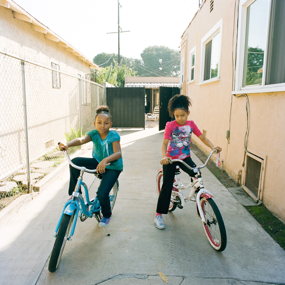   The girls could ride bikes from their house the neighbor's and back, Los Angeles  2013 