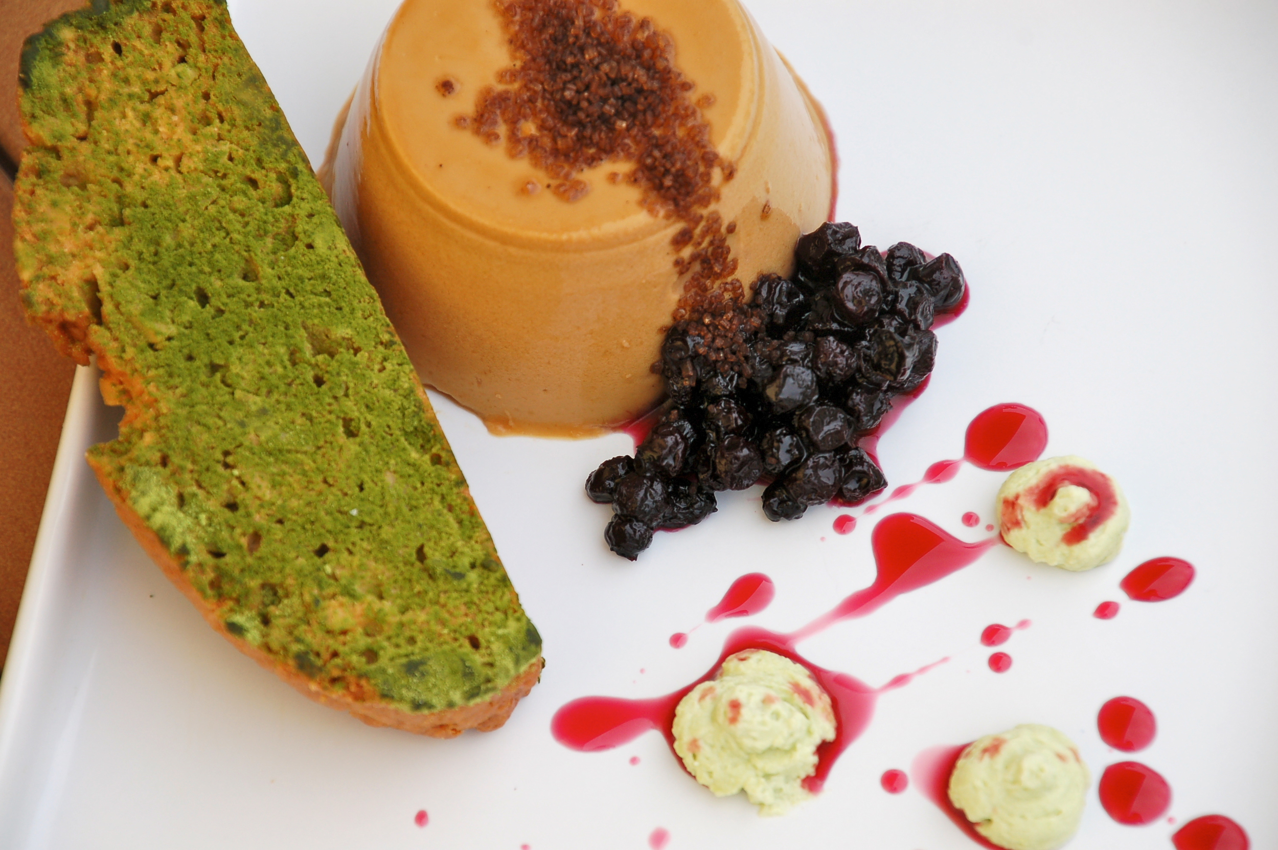 Algarrobina Panna Cotta, carob ben syrup, matcha biscotti, blueberry gastrique