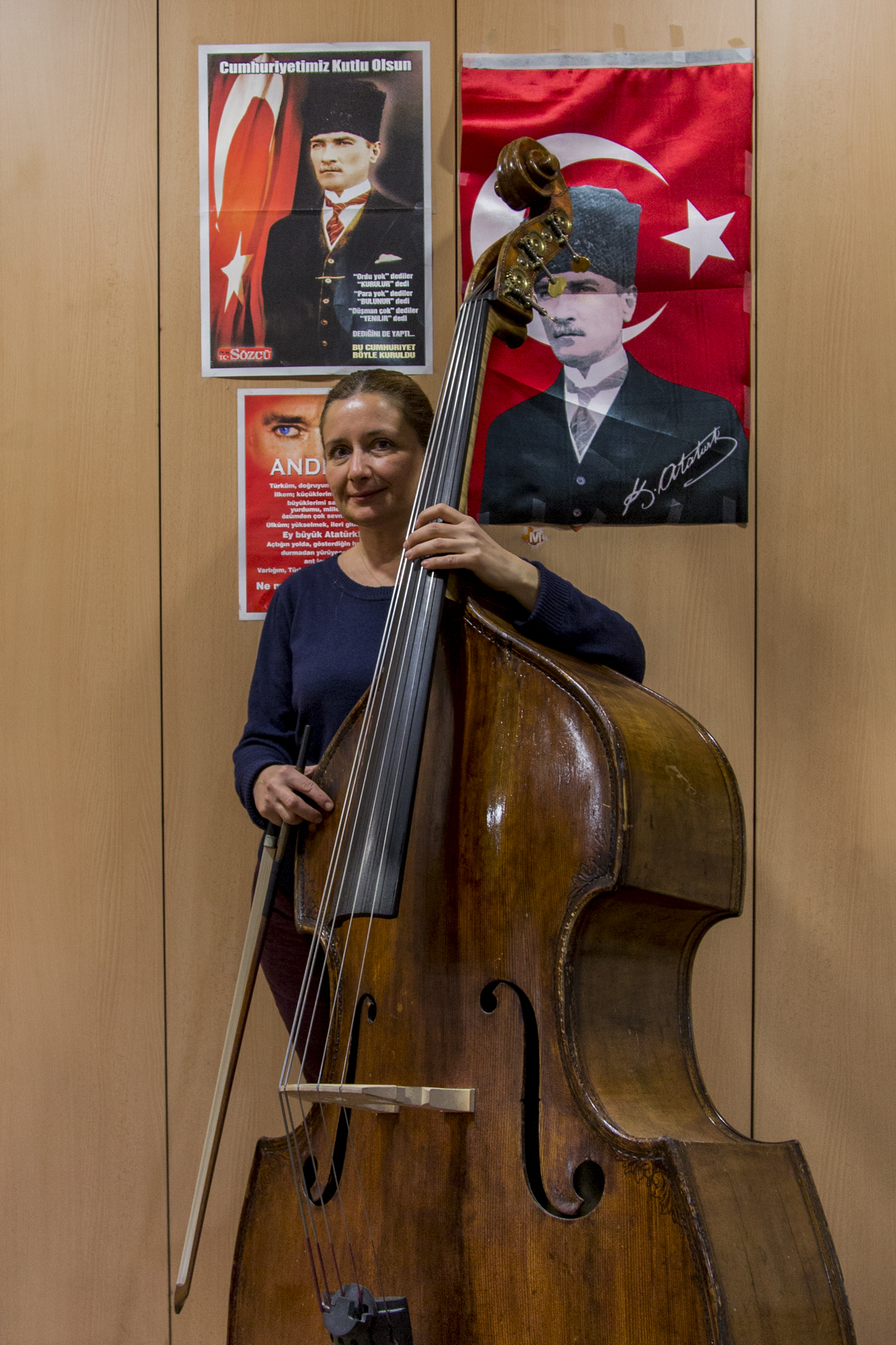 Aylin, a bassist poses in front of her locker decorated with many posters of Atatürk, the founder of the Republic of Turkey, during a break in rehearsals. Ankara, 18th of December 2014.