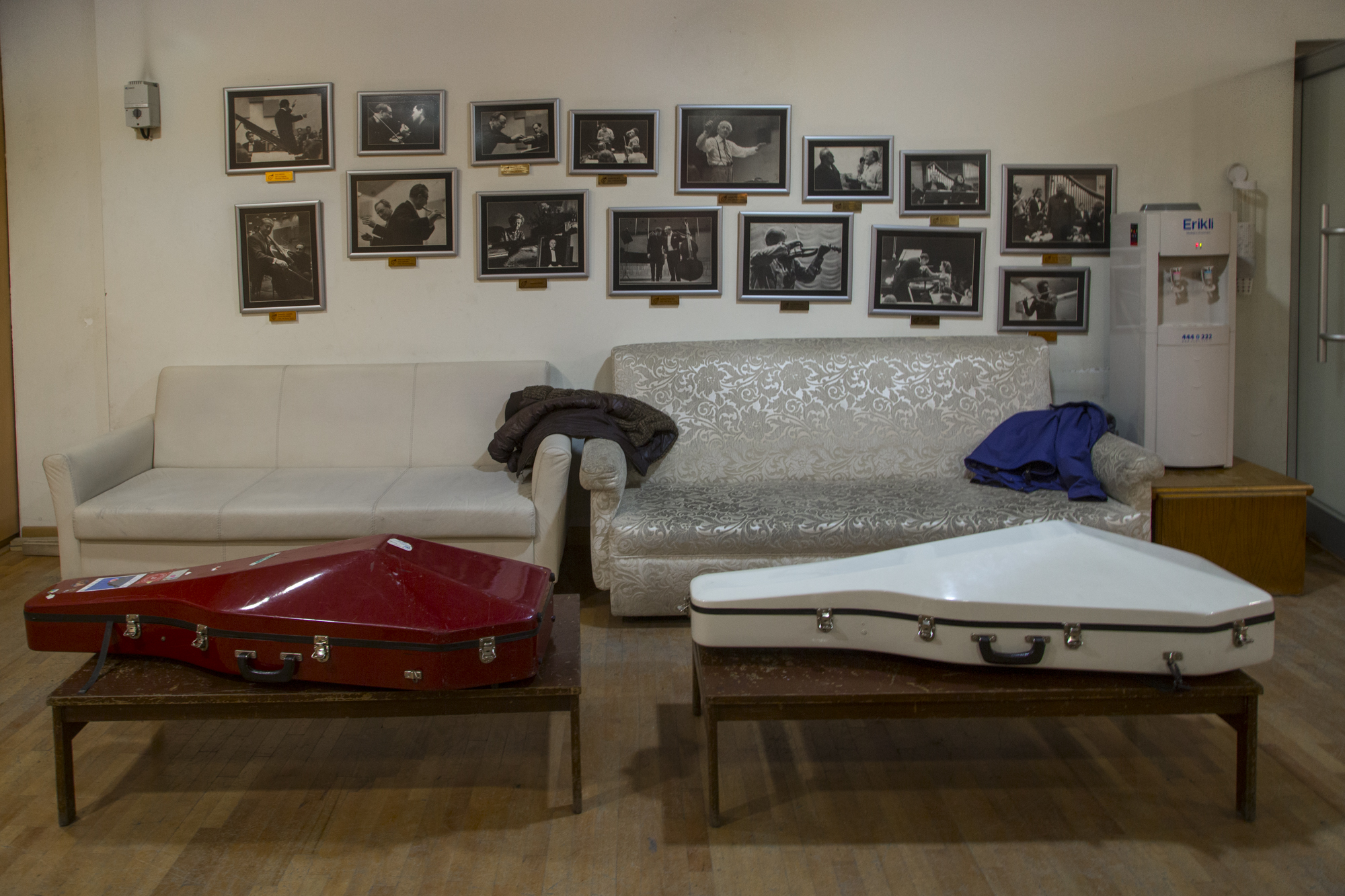  The CSO’s backstage. Cases of cellos lie on coffee tables. Photos on the wall above them are that of previous performances with renowned musicians such as Yehudi Menuhin. Today, less well-known musicians collaborate with the orchestra. Ankara, 15th 