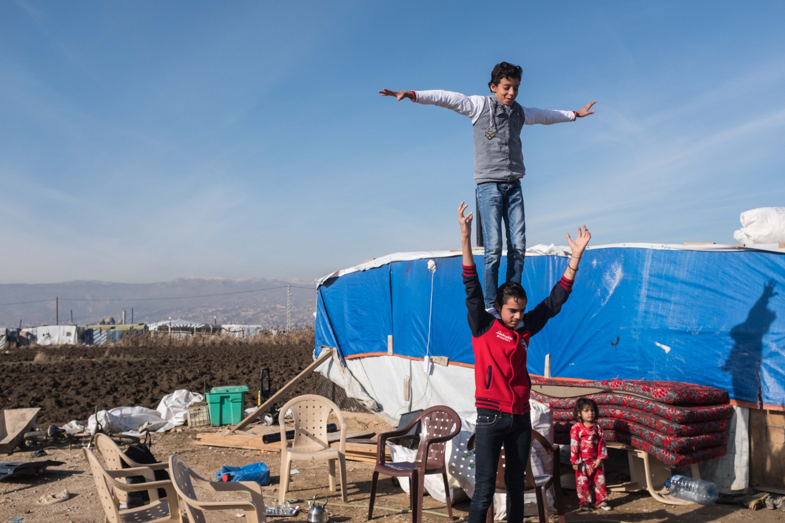  Children show off their acrobatic skills at a small Syrian refugee camp in the Beqaa valley, East Lebanon. 