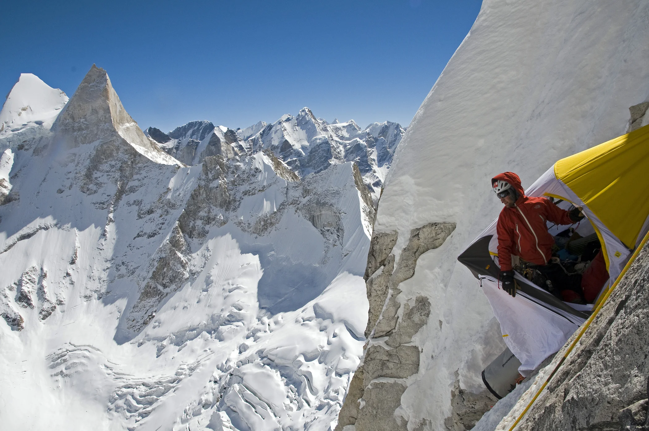 Renan Ozturk assessing the surroundings from Camp II after a cold night in the ledge.
