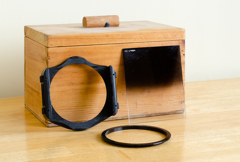 Filter holder, adapter ring, and one of the filters I own for the Cokin P system. The grime on it indicates how often it has been recently used.