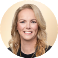 A smiling woman with blonde hair and a black top, set against a light-colored background.