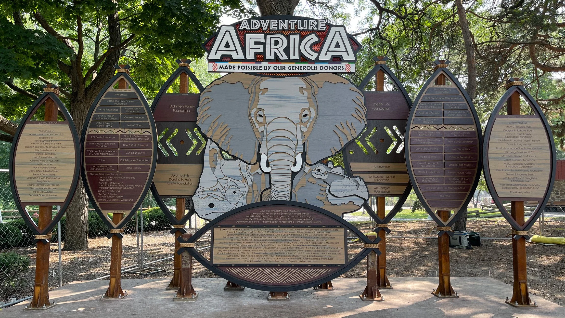 Adventure Africa donor recognition installation featuring dimensional donor panels, animal graphics, wood, and metal.