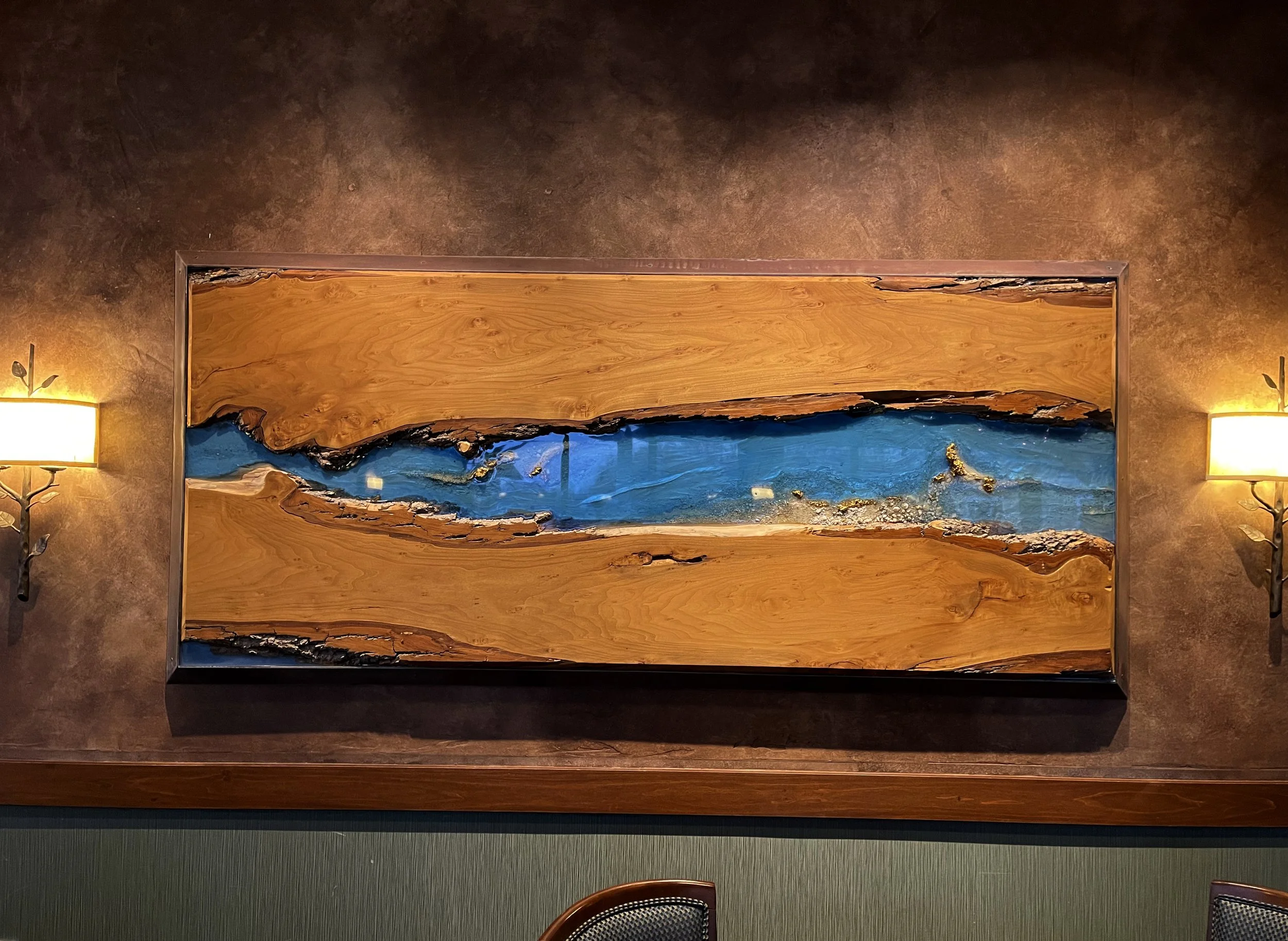 Large-scale custom wall art installation featuring live edge wood with epoxy resin and architectural details.