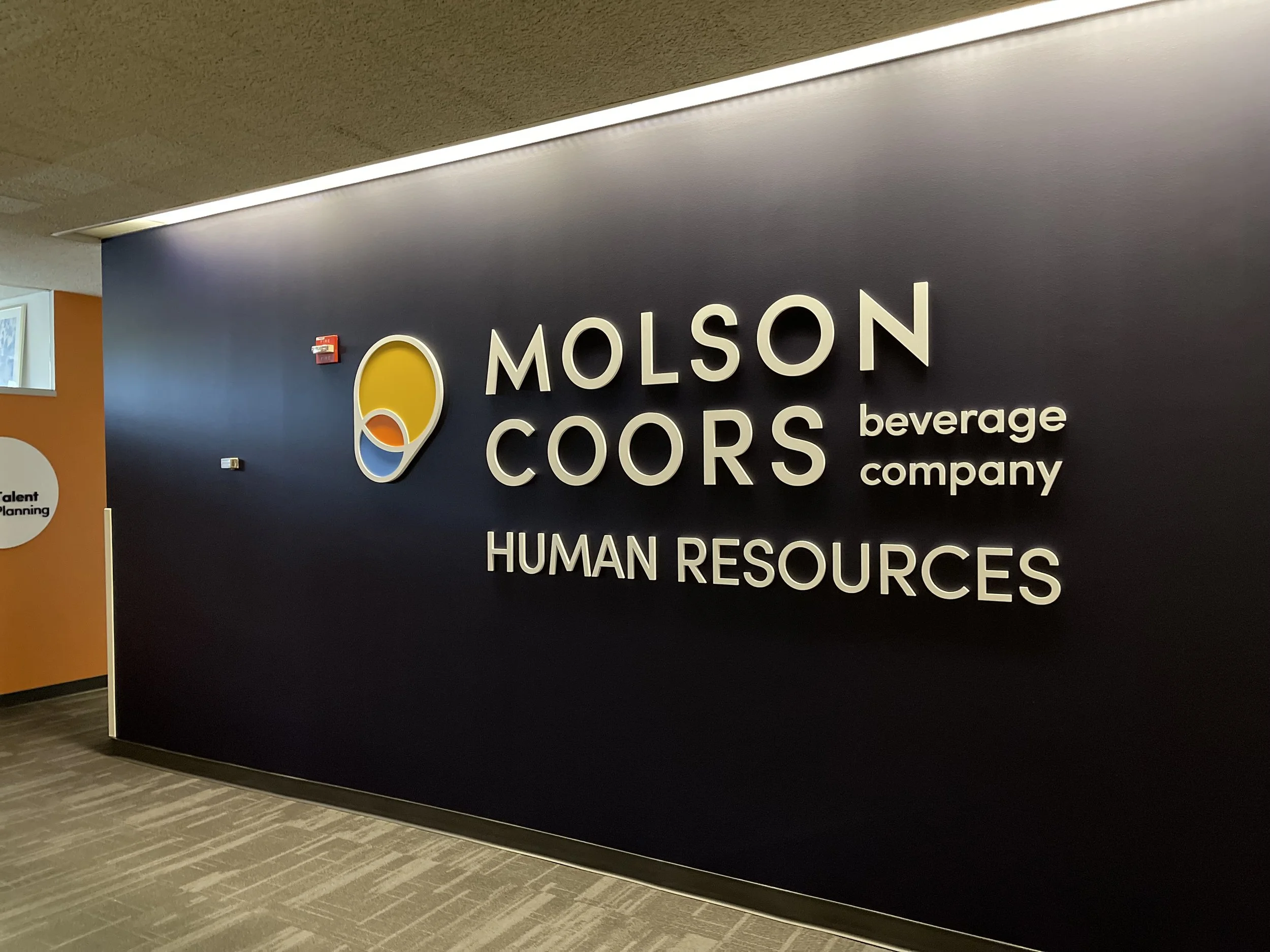 CNC-cut and painted dimensional signage for Molson Coors featuring raised lettering and a custom logo.