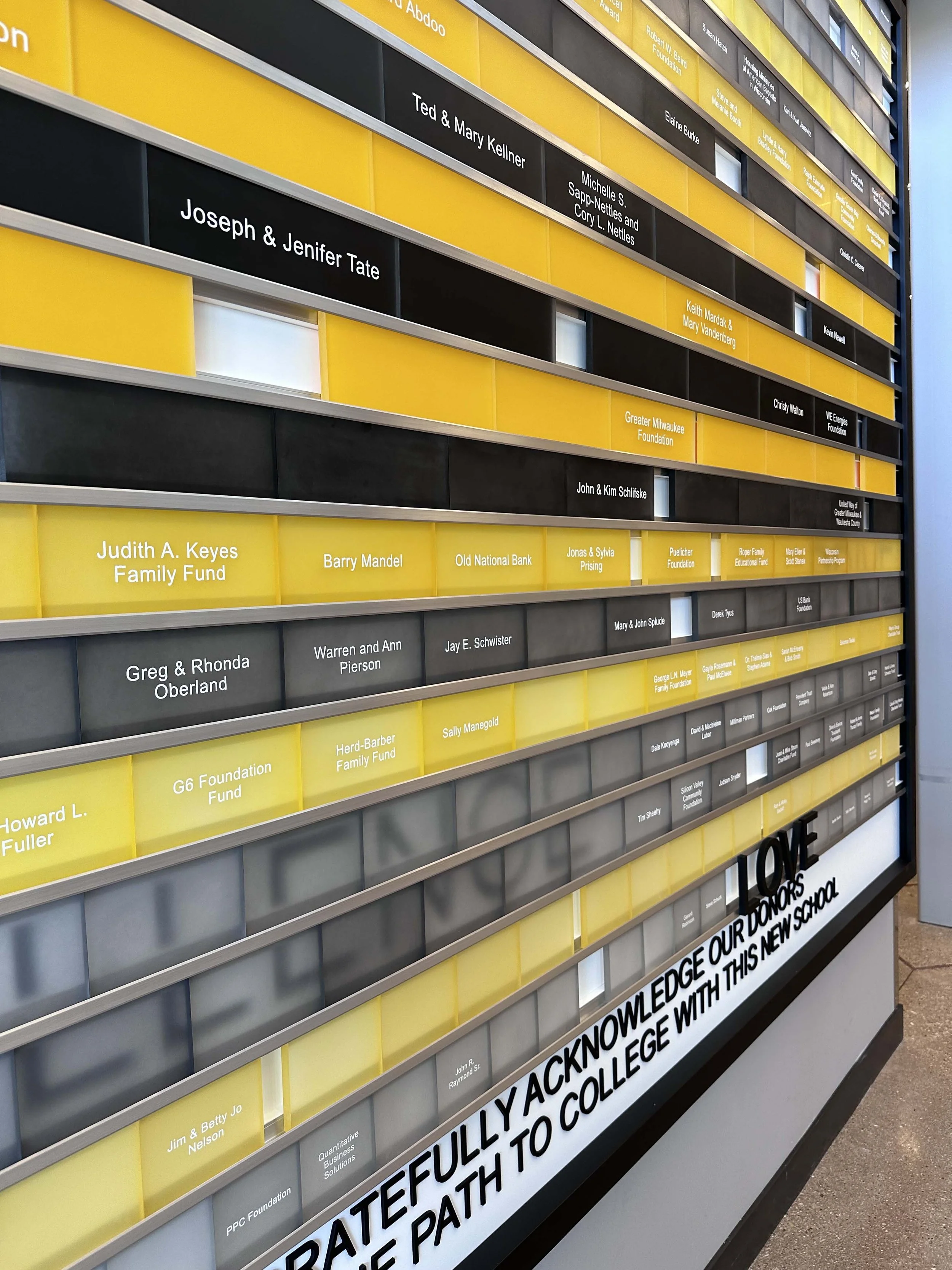 Laser-engraved and hand-stained acrylic donor recognition panels with backfilled lettering.
