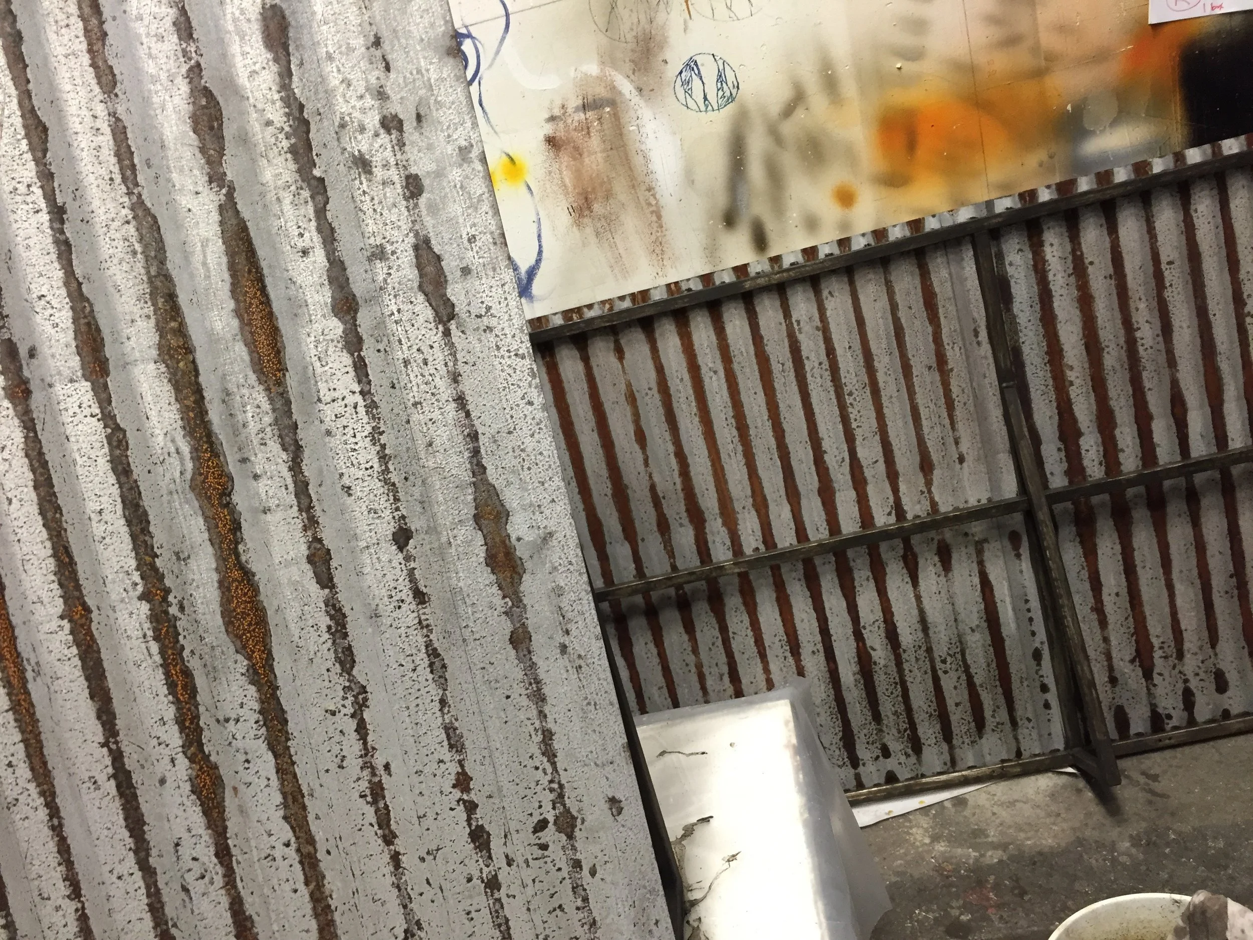 Close-up of metal fabrication materials showing textured and finished metal surfaces.