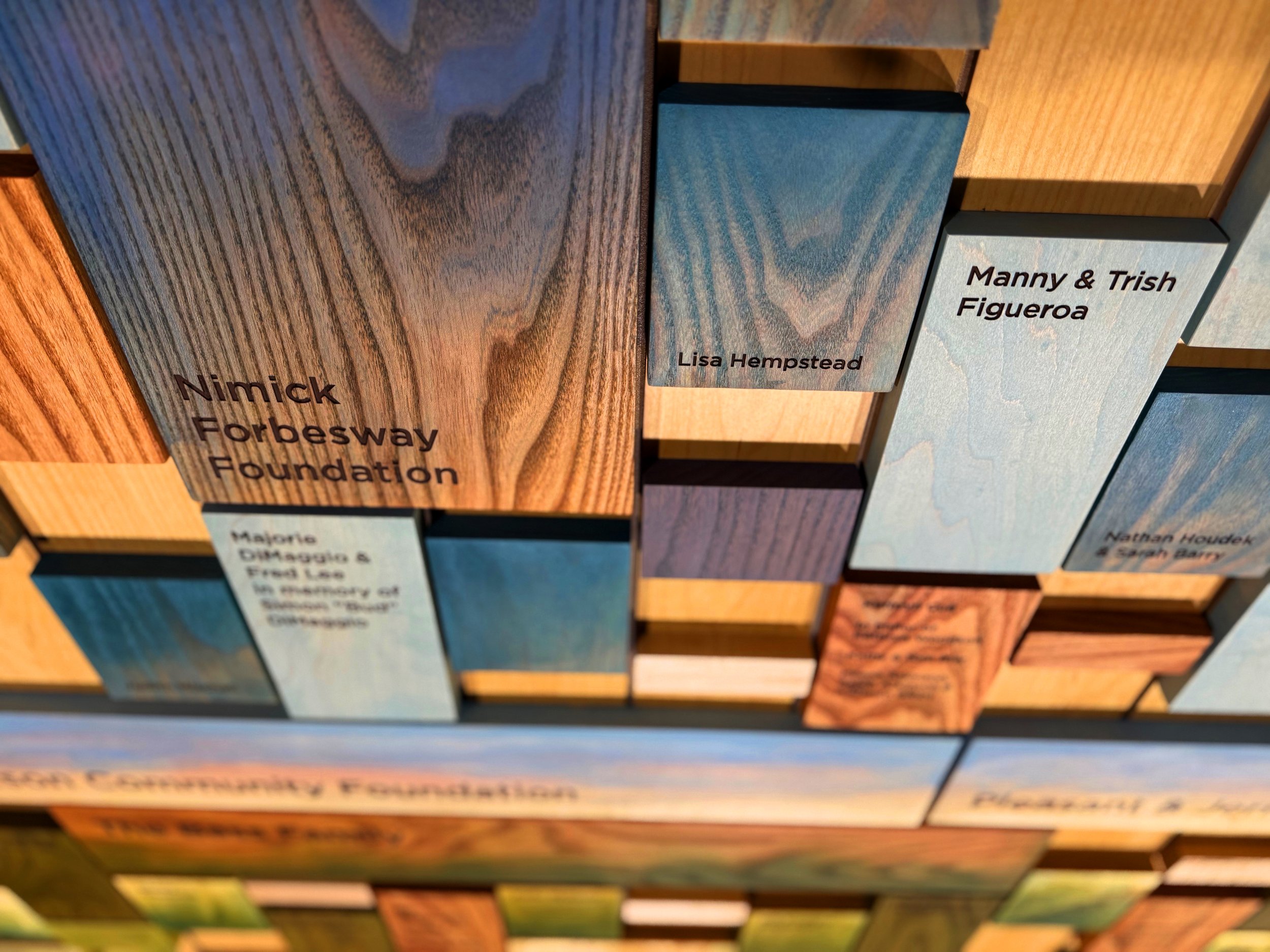 Custom wood samples and finished wood pieces in varied tones, grains, and surface treatments.