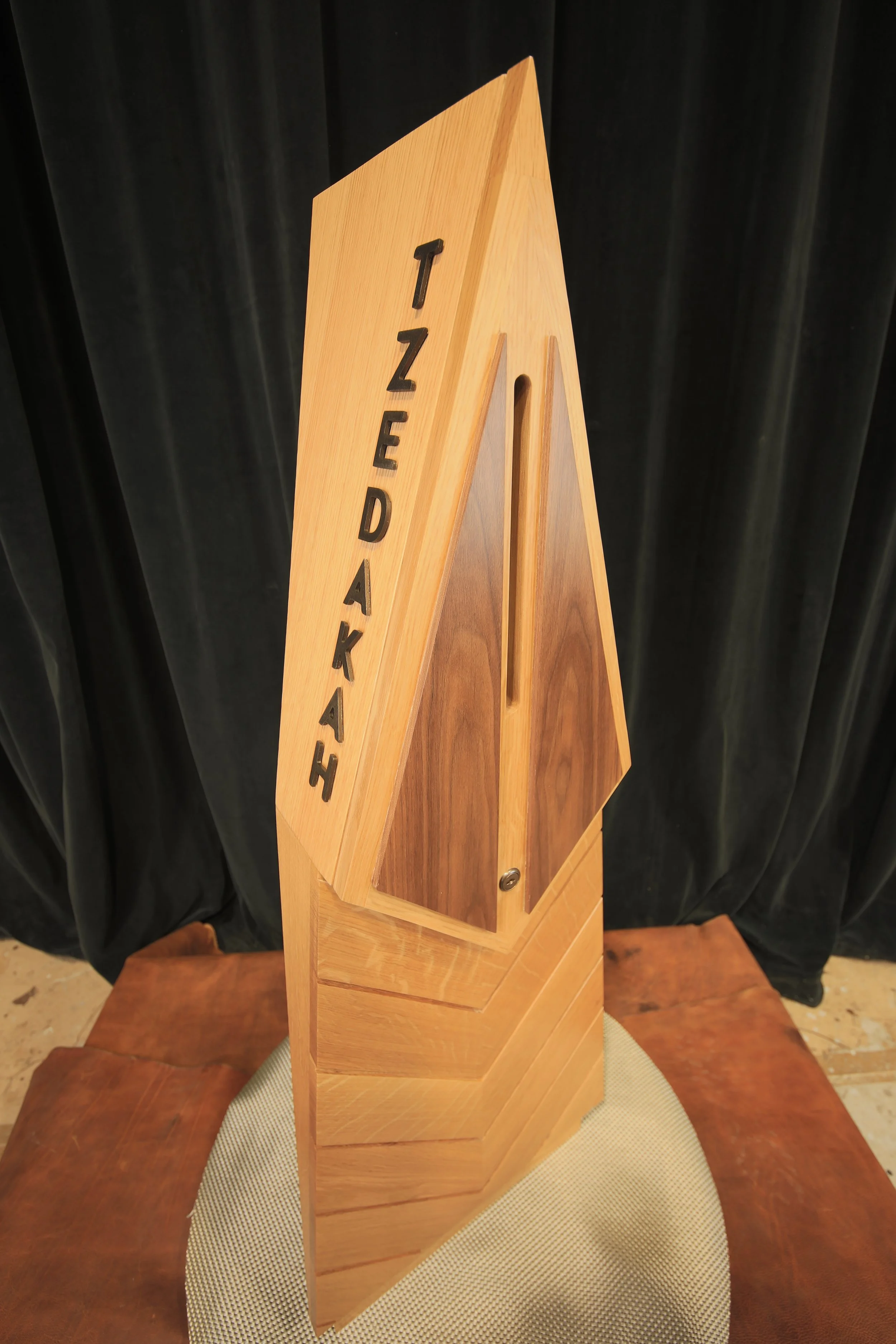 Sculptural wood feature combining layered forms, contrasting wood species, and precision craftsmanship.
