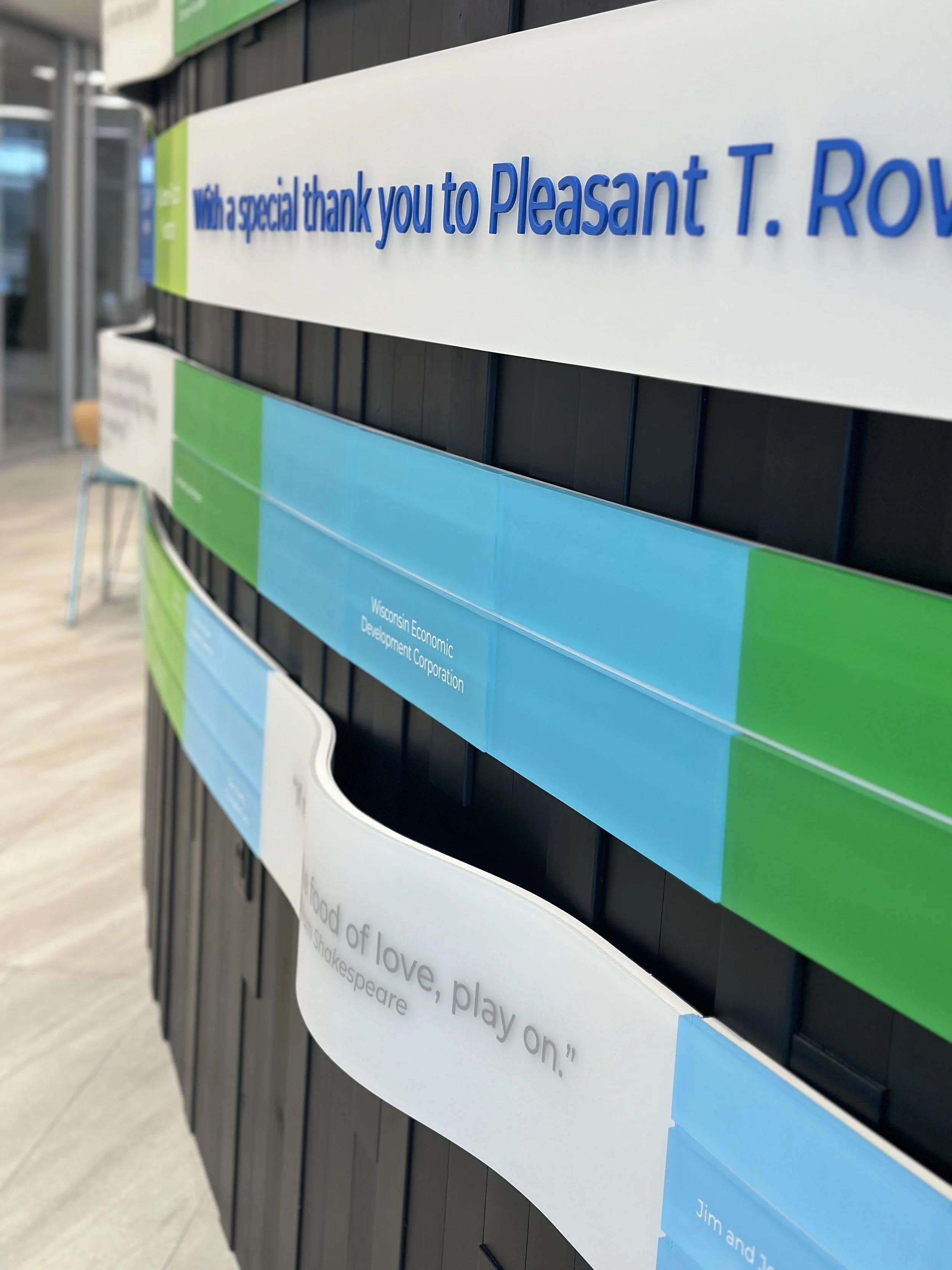 Individual green donor plaques arranged for a modular recognition system designed for future updates.