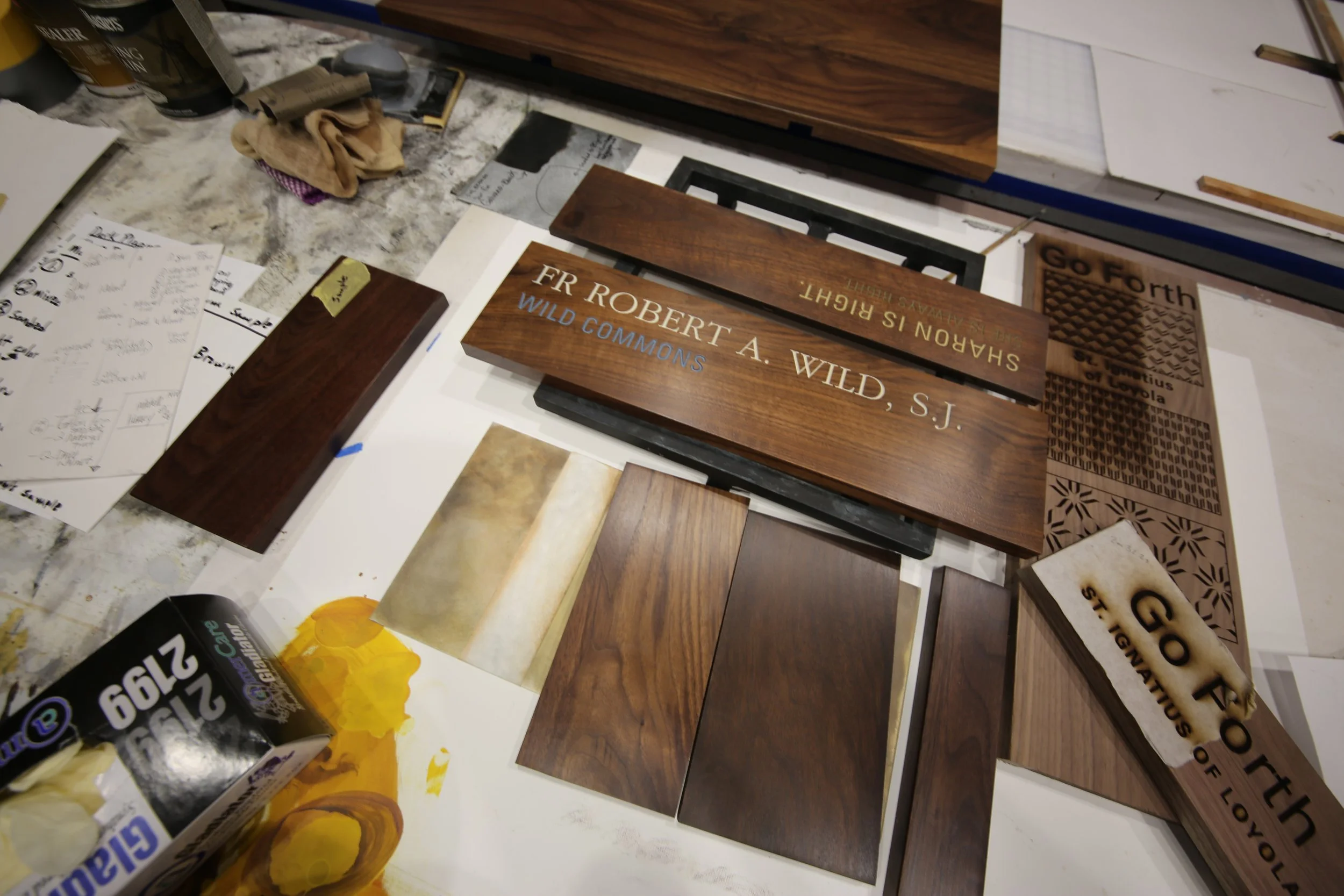 Wood samples, finished components, and material tests used during donor recognition design development.