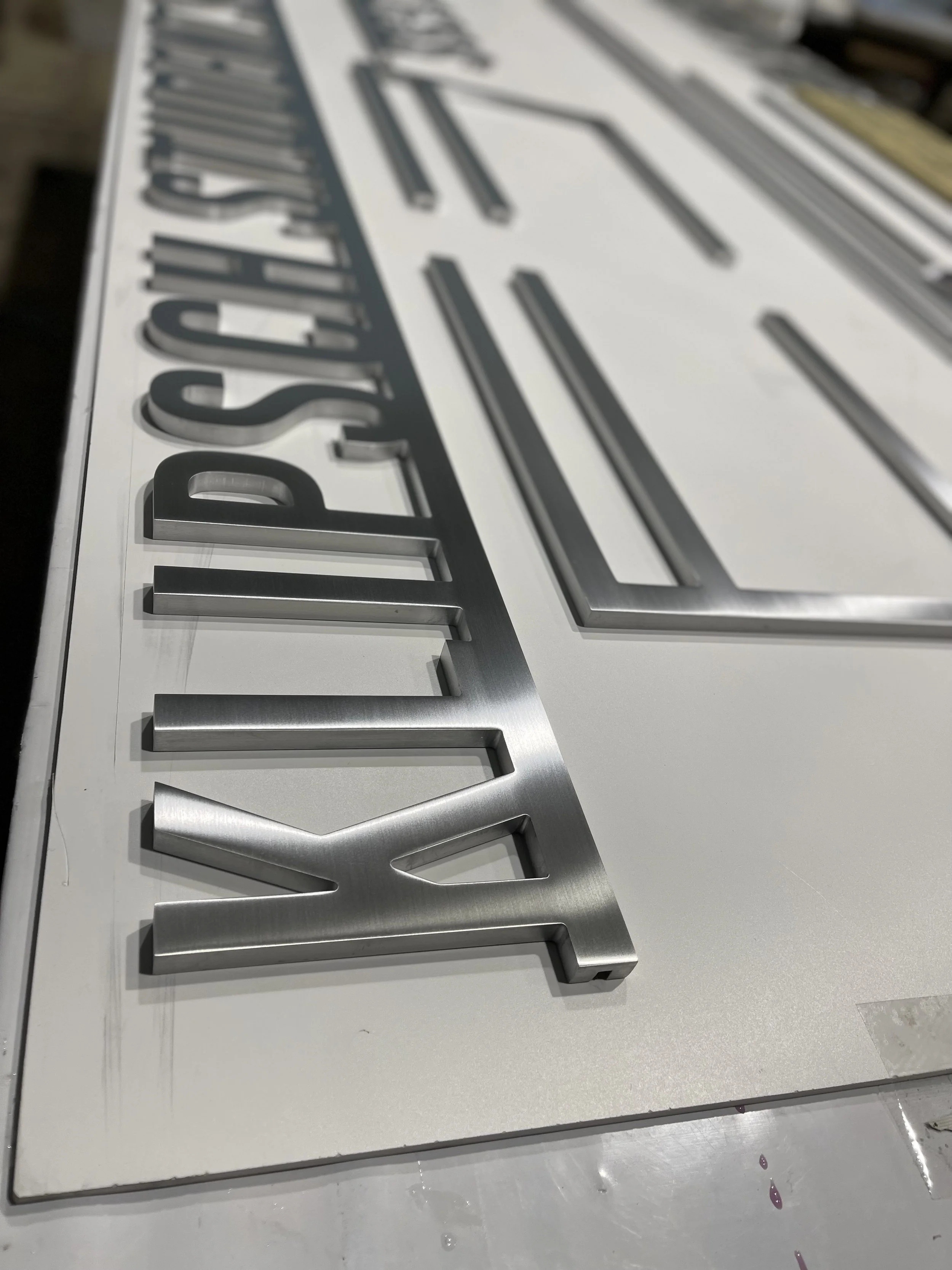 Finished dimensional lettering and fabricated components prepared for final installation.