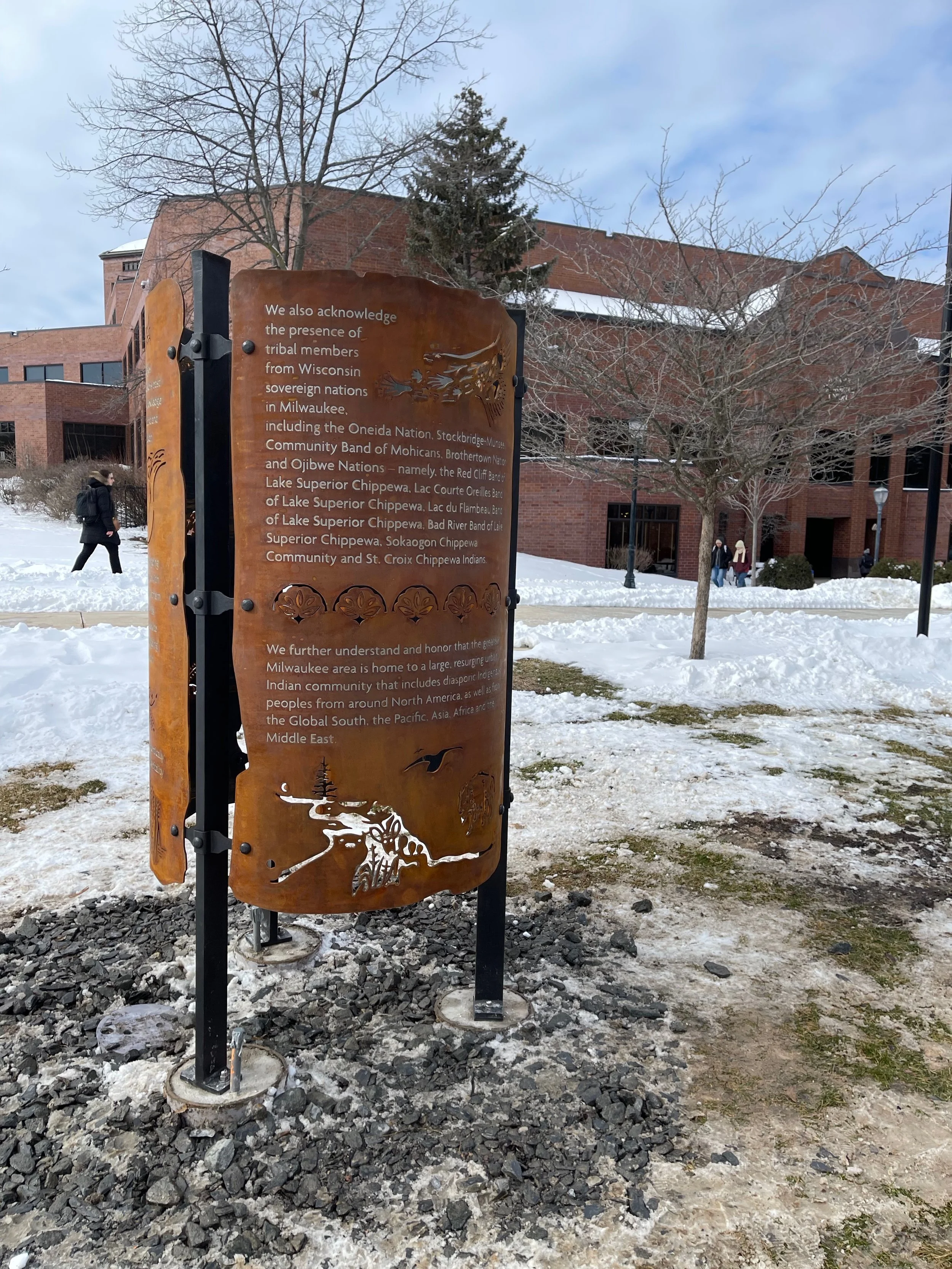 Outdoor custom recognition feature fabricated from weathered steel with cut graphics and interpretive text.