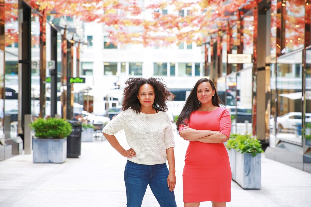  2 Black women in a strong stance facing the camera in City Center, Washington, D.C.  Photos:  Milli Mike / Millgrimage  