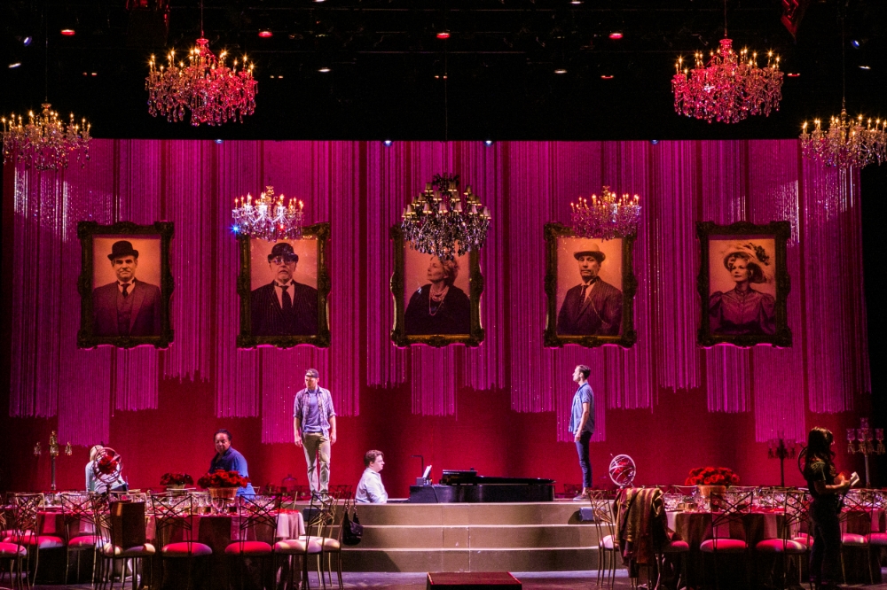 In addition to the event signage and print items, I also contributed to the experiential elements as I produced the altered and weathered photos of the "suspects" of the evening, hanging as part of the decor of the on-stage dinner.