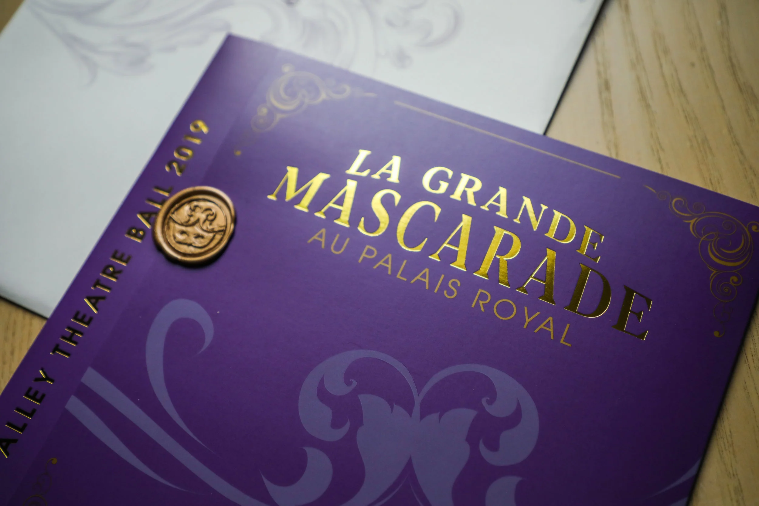 The Alley Theatre Ball is an annual black-tie fundraising event, and the theme for 2019 was a Masquerade Ball (spelled “Mascarade” in French) loosely tied to the theatre’s production of The Three Musketeers , which takes place in 17th century France. The team’s inspiration for this aesthetic came from the ornate golden designs of the 17th century French Rococo period of art history. We produced an invitation and letterhead suite, as well as printed materials for the event itself.