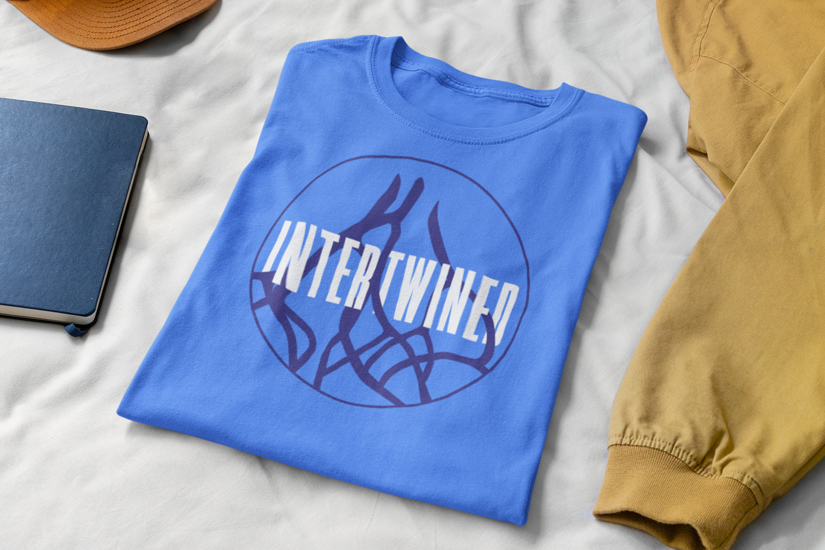 mockup-of-a-folded-t-shirt-on-a-bed-with-some-working-tools-33921.png