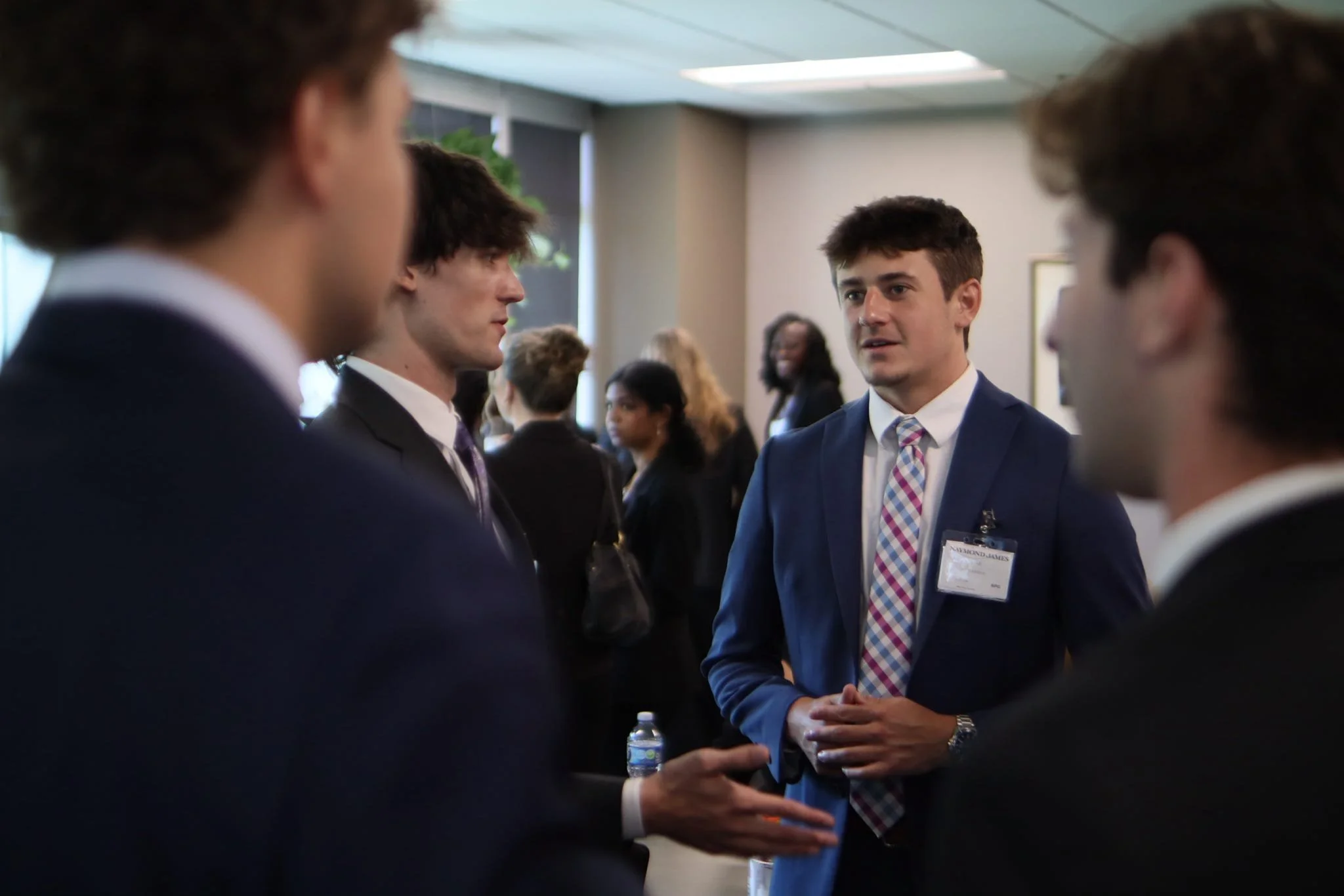 A group of brothers and a guest speaker talking in a circle.
