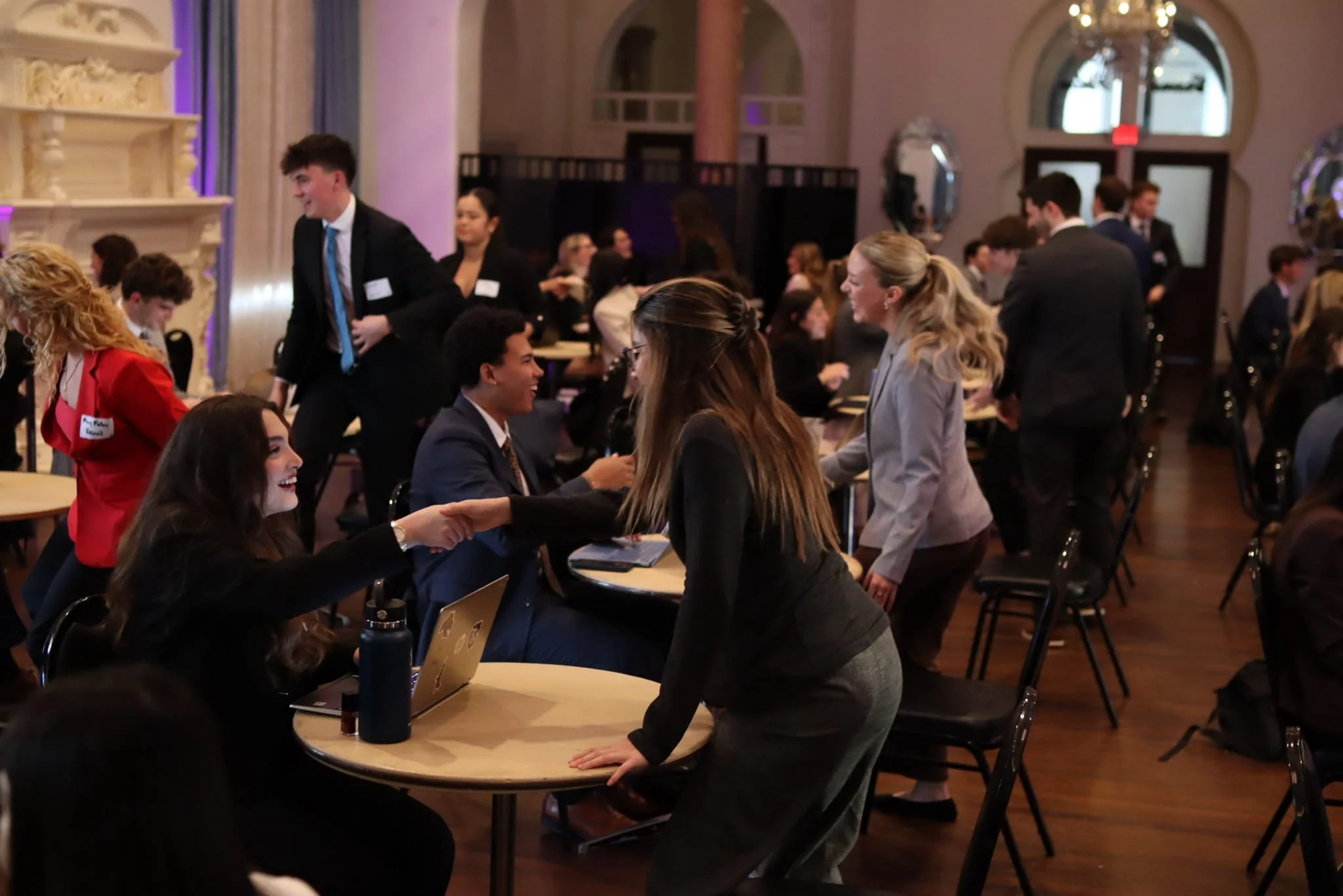 Students participating at the Speed Dating dating event, where every recruit is sitting infront of a brother.