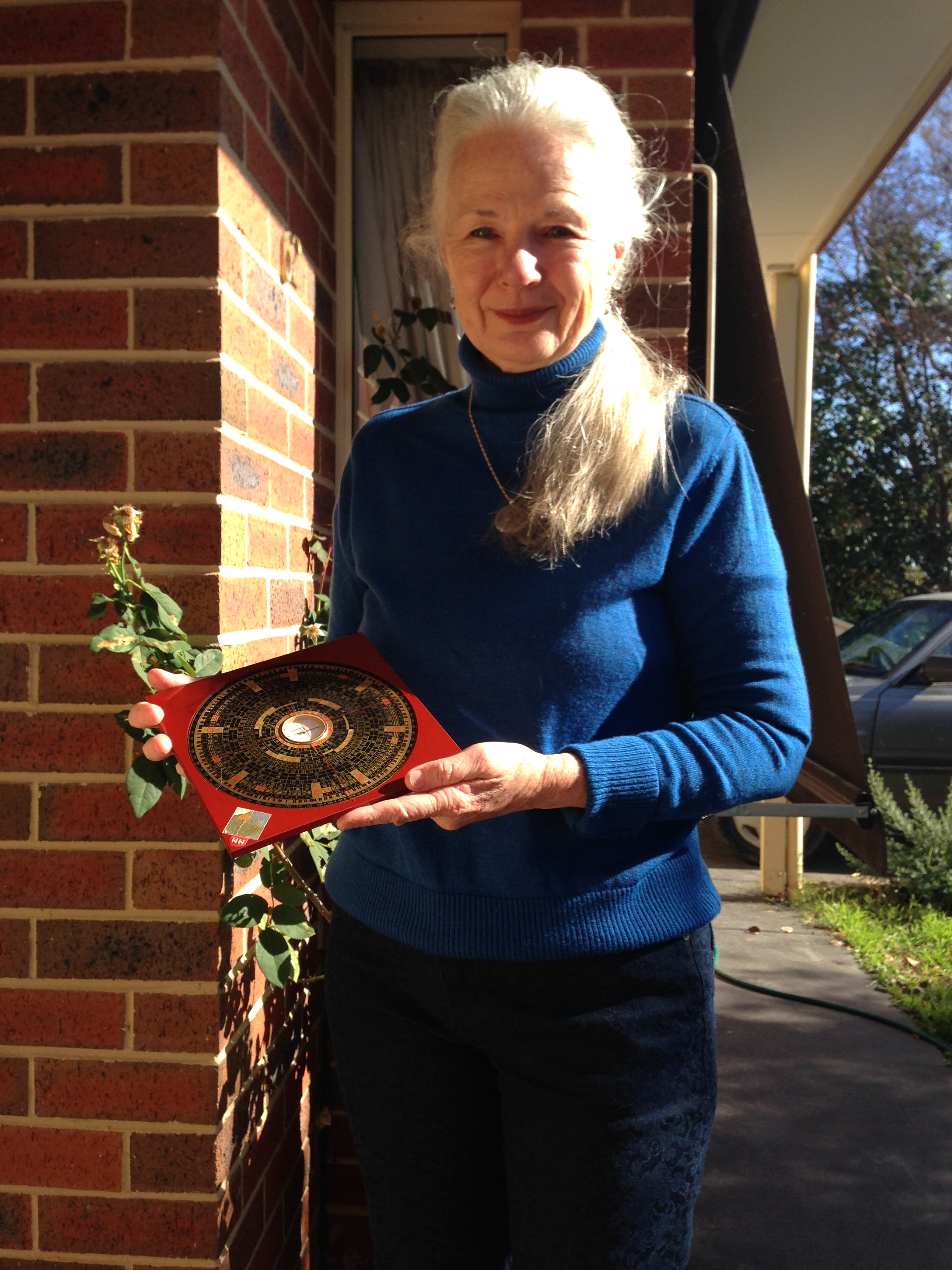 Melynda using her Luopan in a Feng Shui consultation.