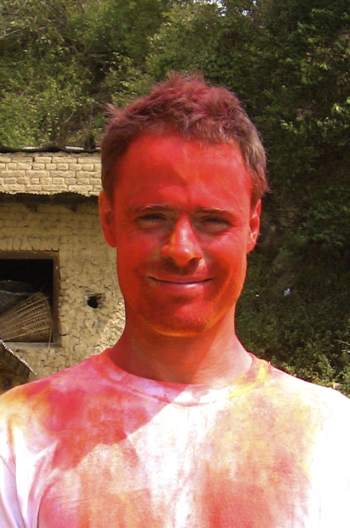 Holi in a poor Nepalese village, and all they could afford was red. And it smelled like gasoline. All those bright Holi colors are made of the same petrochemical derivatives, and should be banned. Traditionally it was herbal powders or food extracts that were used. So it’s also a picture of mind over matter. Smile and celebrate despite smelling like gasoline (mostly because everyone else does too!) - todd caldecott