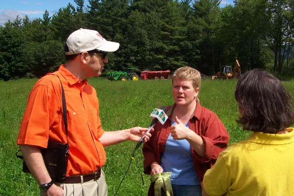 A New Hampshire Public Radio reporter interviews the owner of a hay field as biosolids are being applied (central NH).