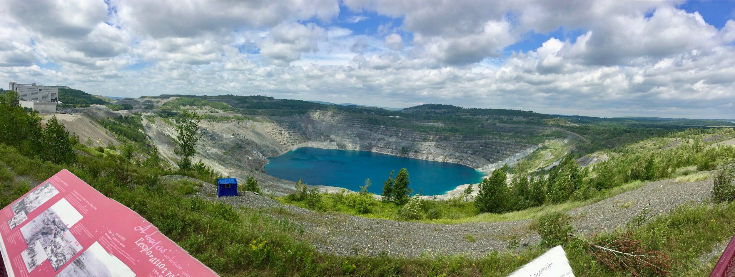 Looking northwest at the open-air Jeffrey Mine from a small park at the north edge of the town of Asbestos, QC. Note the plateaus of mine tailings - a total of ~800 hectares (1977 acres) - in the distance.