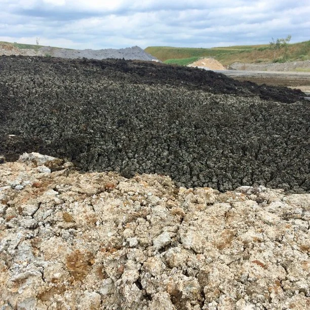 Gypsum residuals (foreground), wastewater biosolids (middle), and paper mill residuals (gray in back) are part of the soil mix used to restore native soil and plant ecosystems at Asbestos, QC.