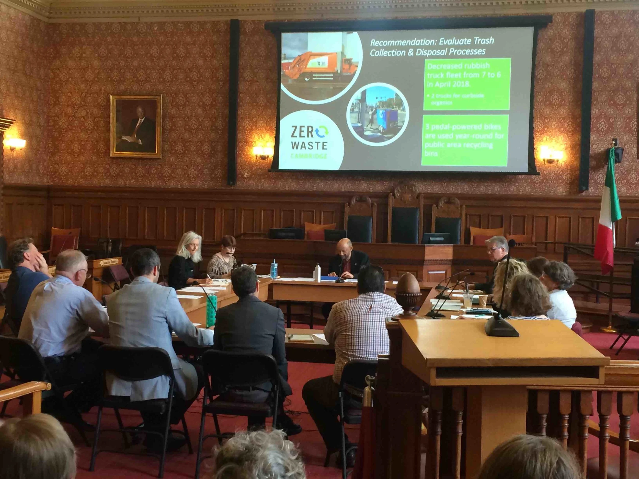 The Cambridge City Council’s Health and Environmental Committee (Co-Chairs Quinton Zondervan, back center, and Jan Devereux, back left) hear from City recycling program staff at a public hearing Oct. 9, 2018.