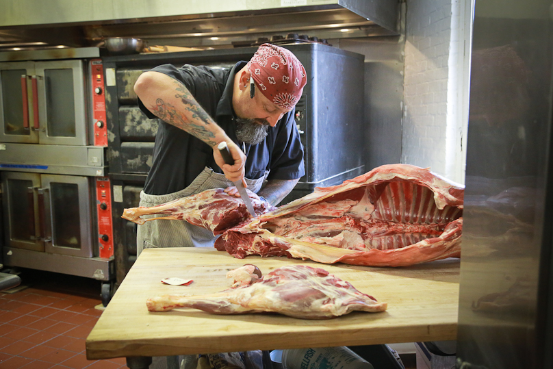  Chef Brian Alberg of The Red Lion Inn breaks down a whole mutton from Lila Berle's farm for the event. 