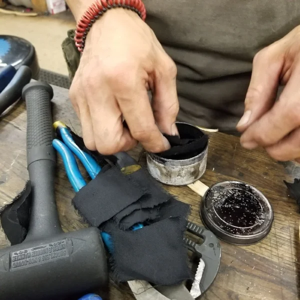 Cloth swatches are cut and placed in tin