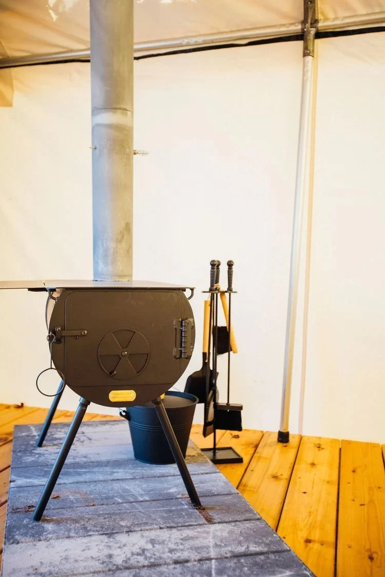 Wood burning stove in Forest Hut at Rising Sun Retreat.