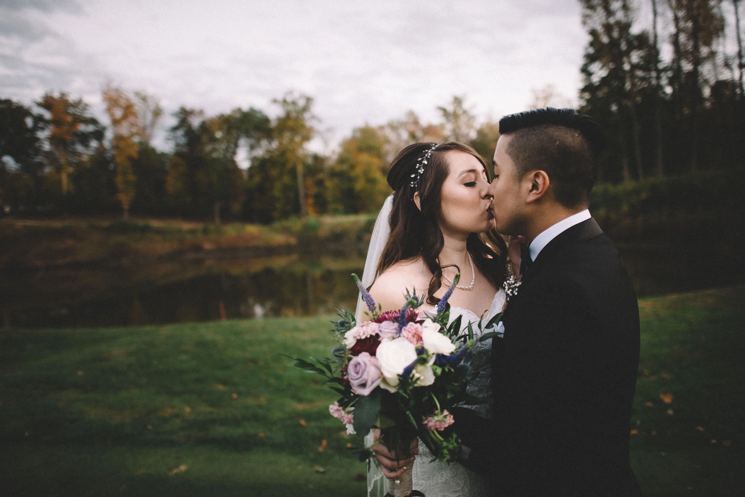 The bride and groom share a kiss on their wedding day.