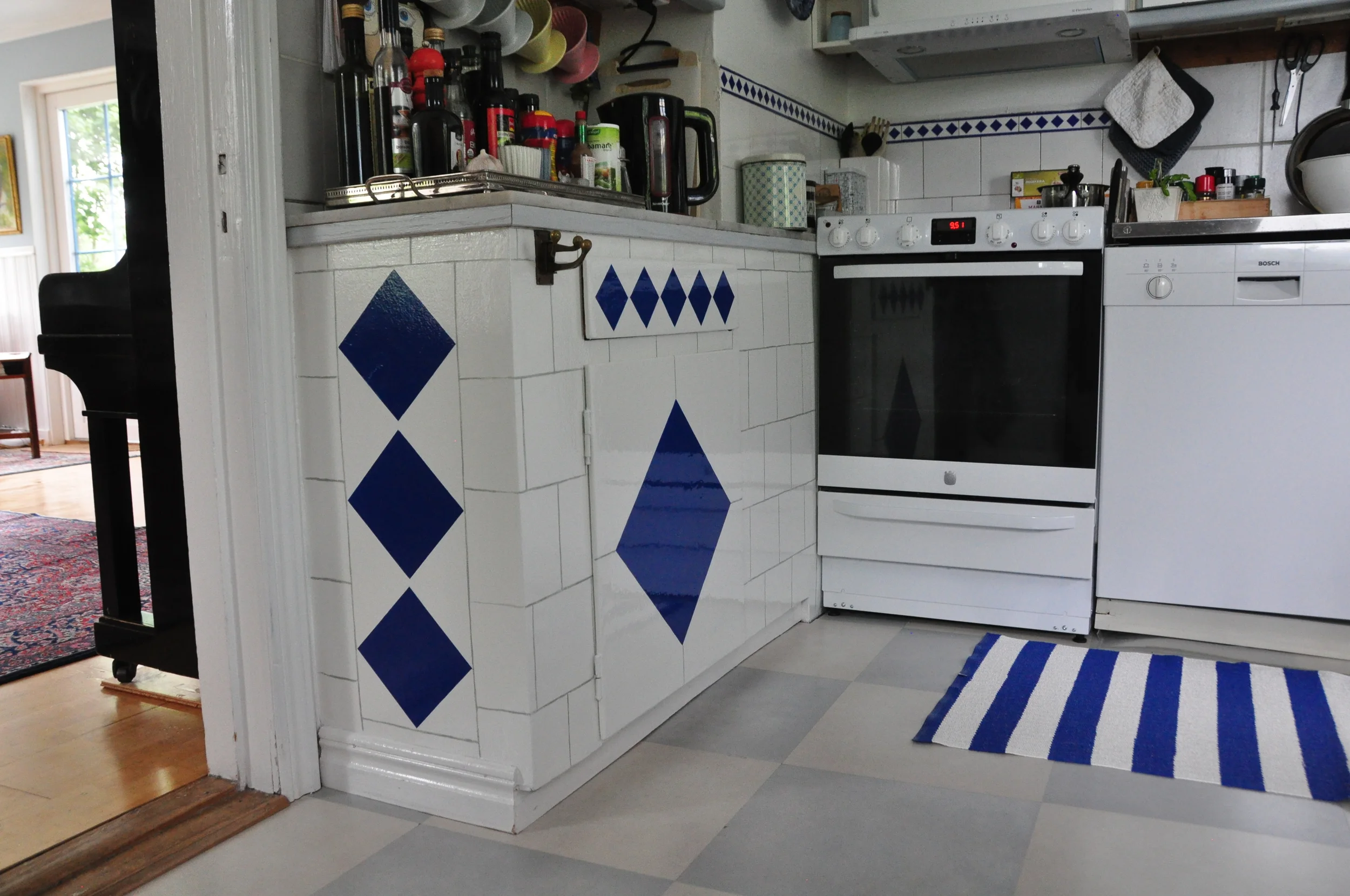  Painted the wood cabinet to match the tile around the stove. 