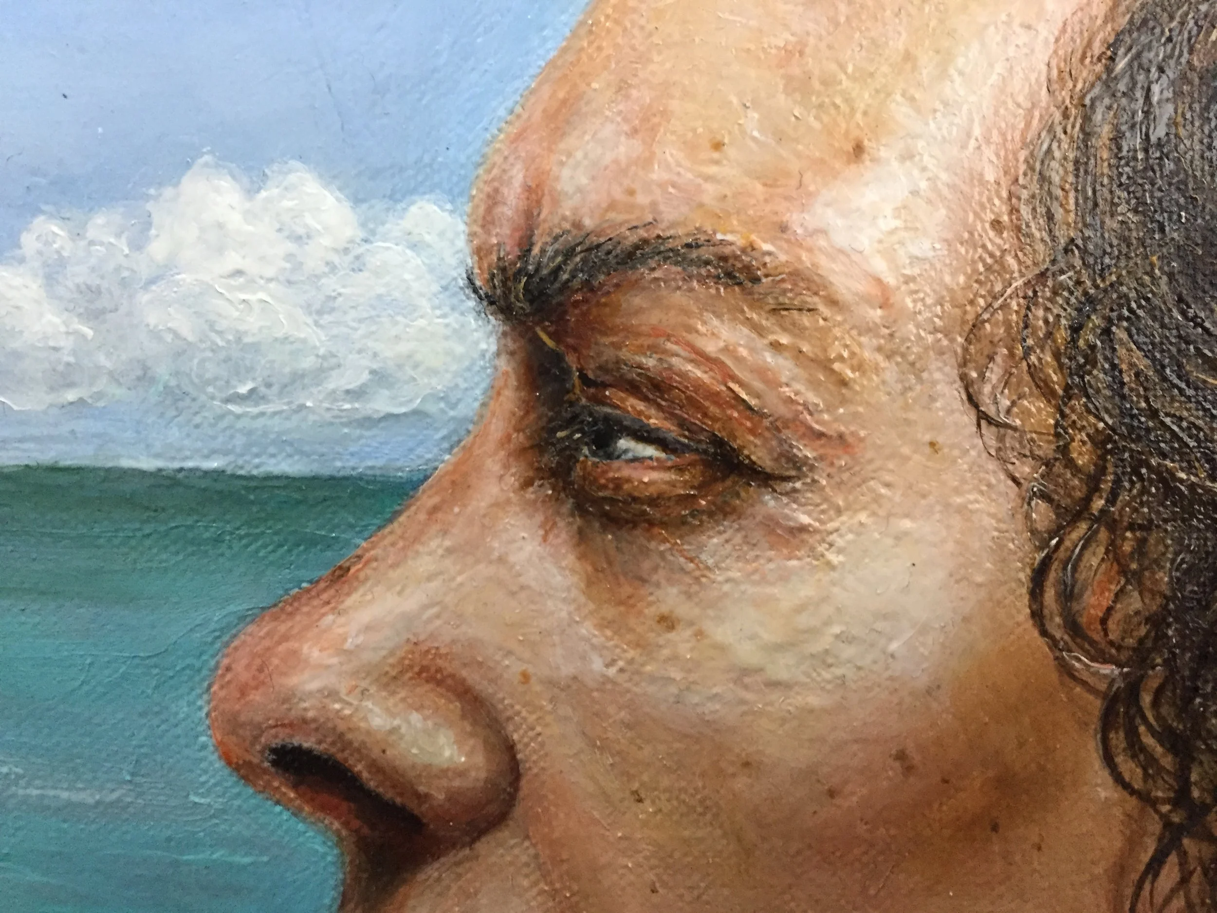 Close-up of a detailed painting or mural showing a person's face with curly hair and closed eyes, against a background with clouds and sky.