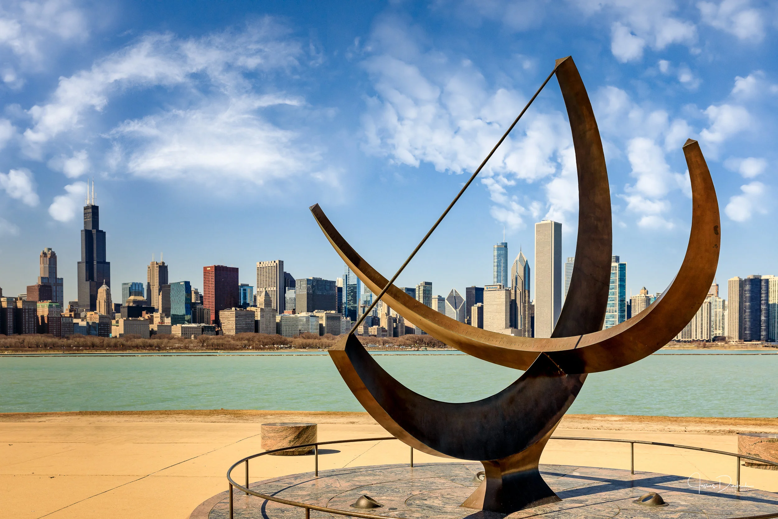 The Chicago skyline as seen from Adler Planetarium. Man enters the Cosmos sundial is in the foreground.