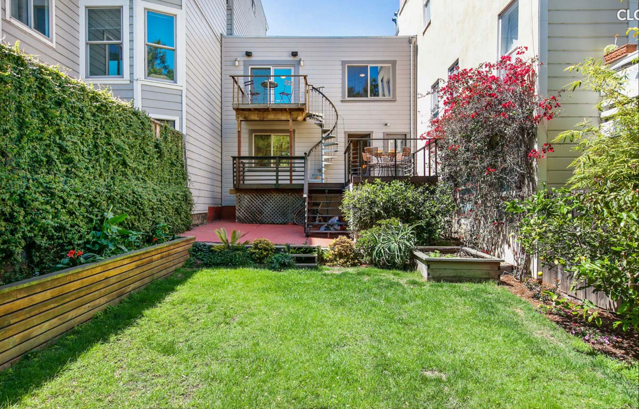 BEFORE: A diminutive little house in between to two towering buildings.