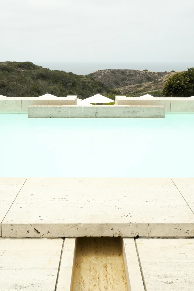 The water feature in the plaza ends in a beautiful aqua lap pool.