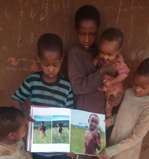 Barabaig children enjoying Lane's book, Barabaig: Life, Love and Death on Tanzania's Hanang Plains