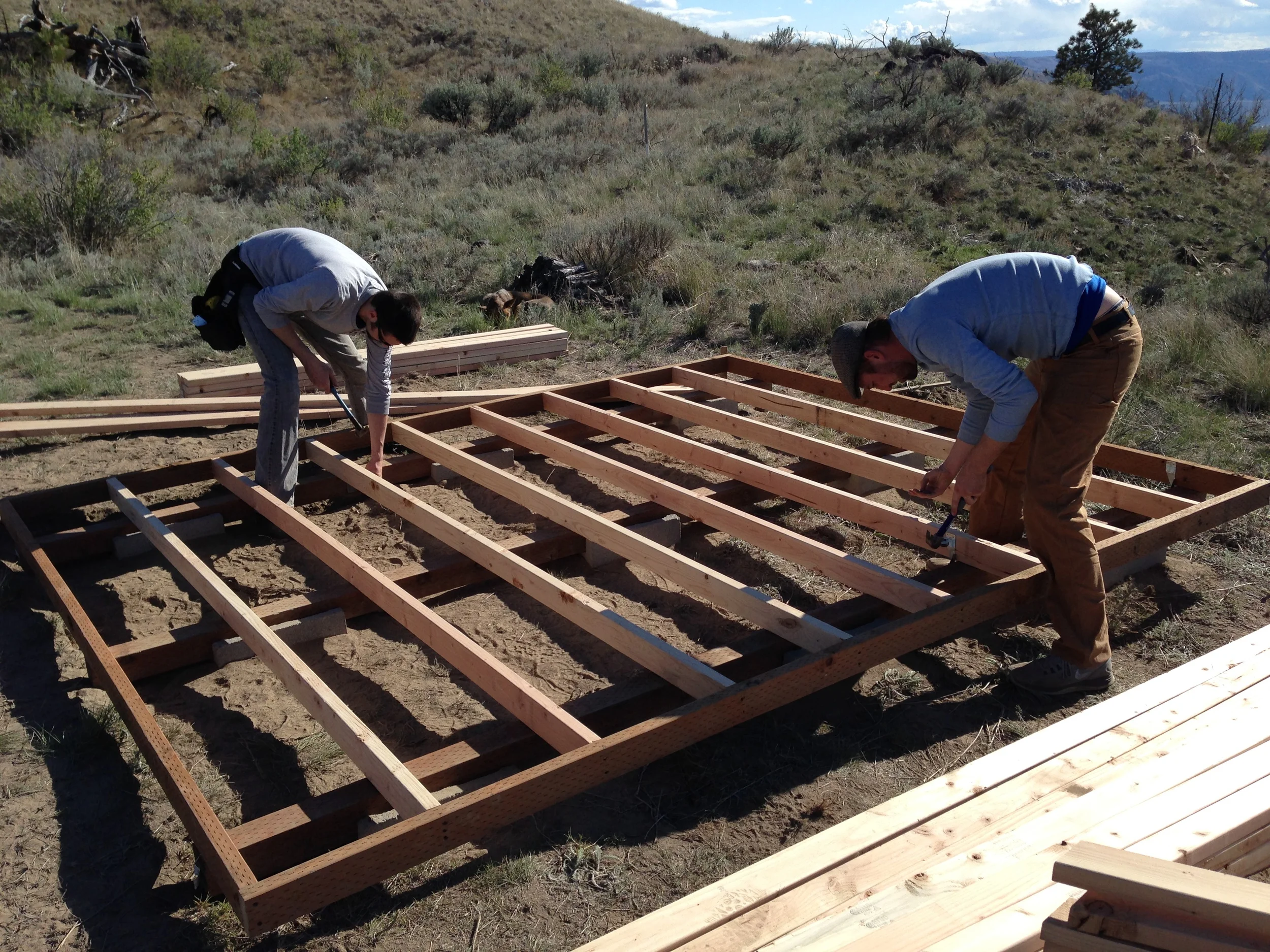 Joists being tied into the skids with metal rafter ties.