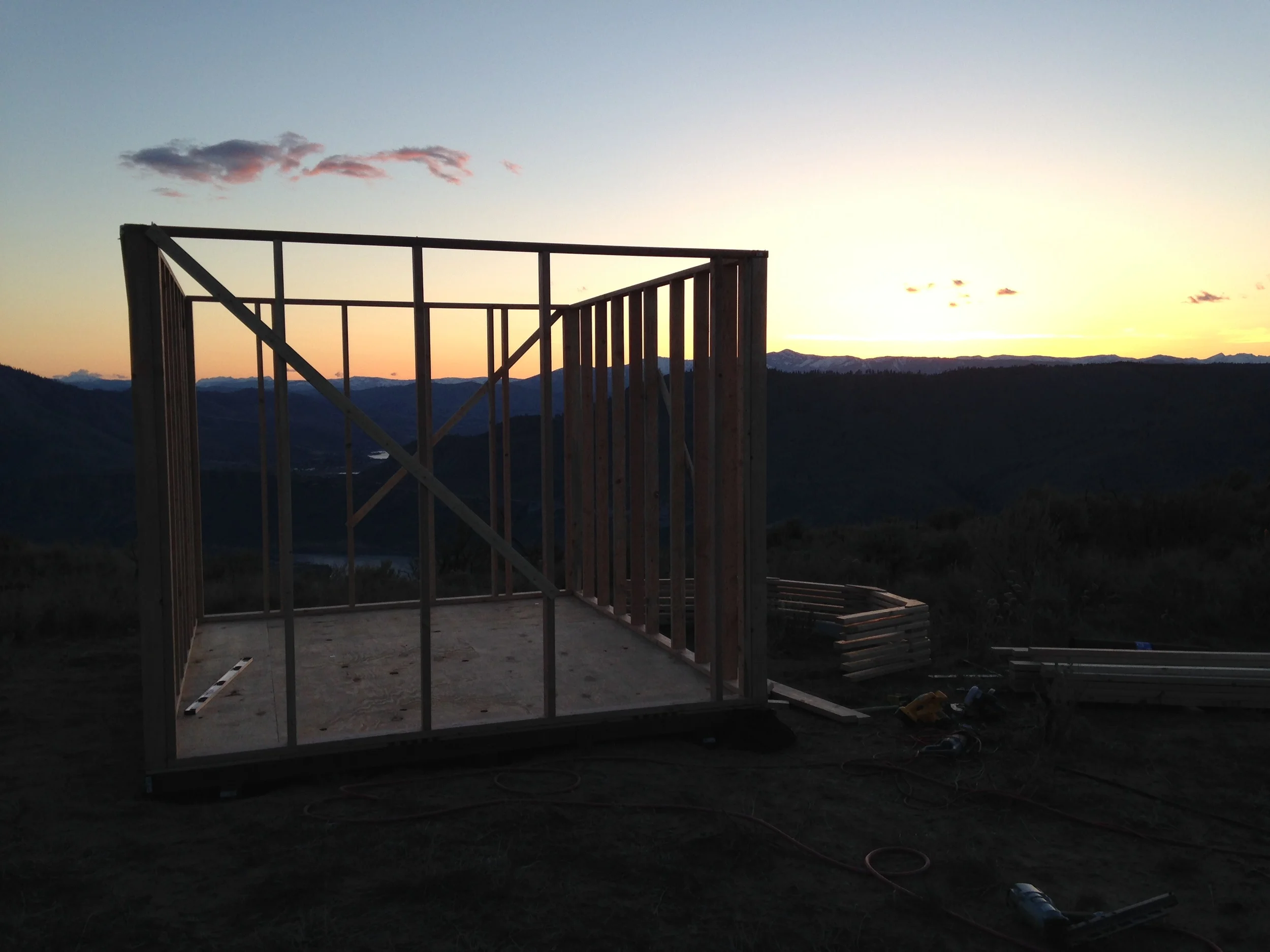 The first day of building complete. A foundation, a floor, and a stick frame.