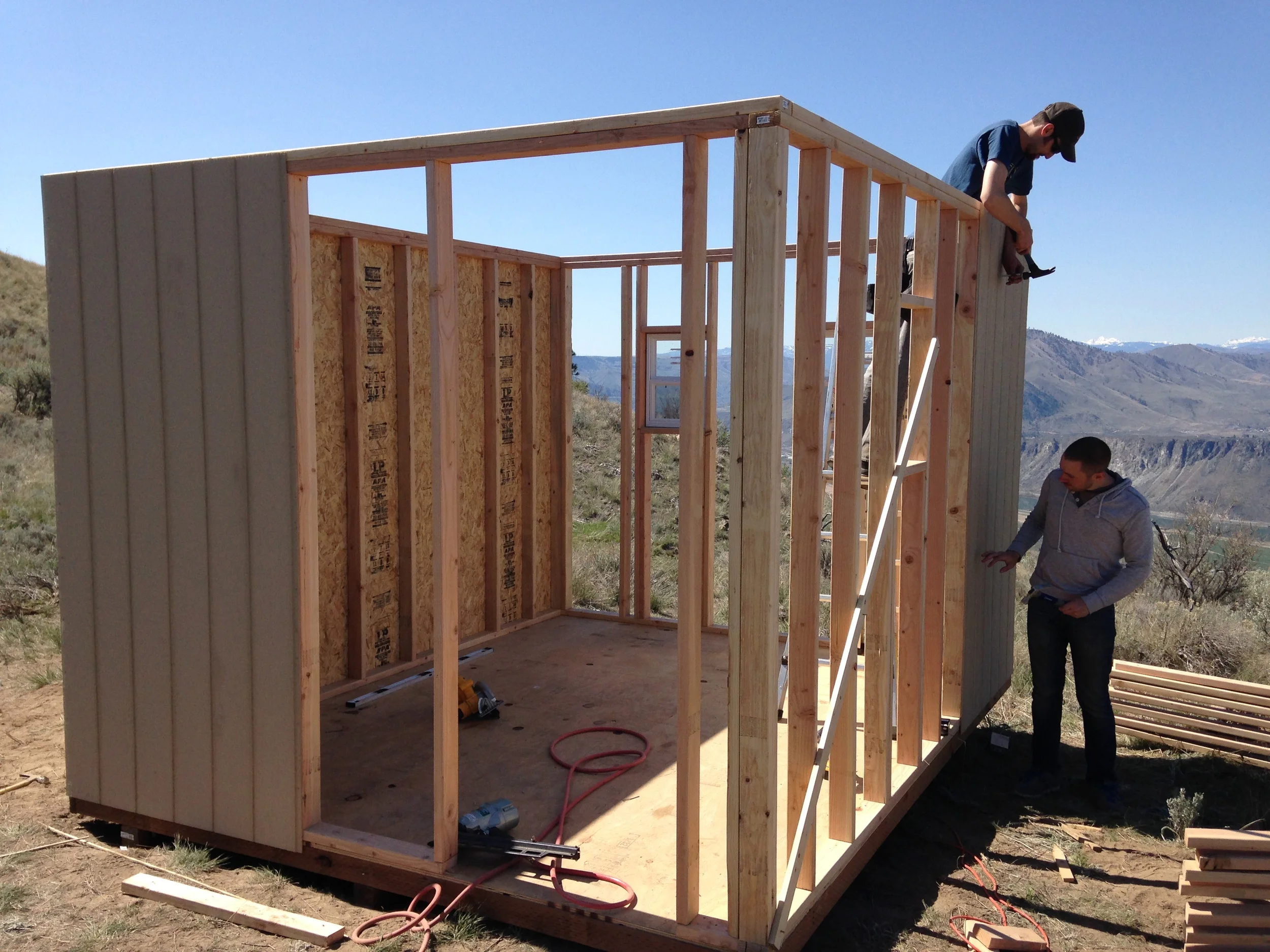 Justin and Alex work on more siding.