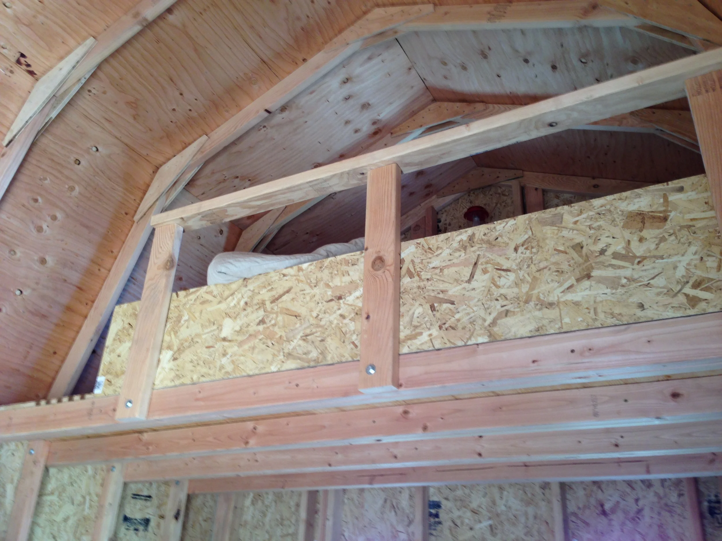 We fastened the railing to the joists with the same hardware used to attach the joists to the studs, making the railing extremely sturdy. The extra piece of siding was a temporary wall to prevent my phone and eyeglasses from getting knocked off unintentionally.