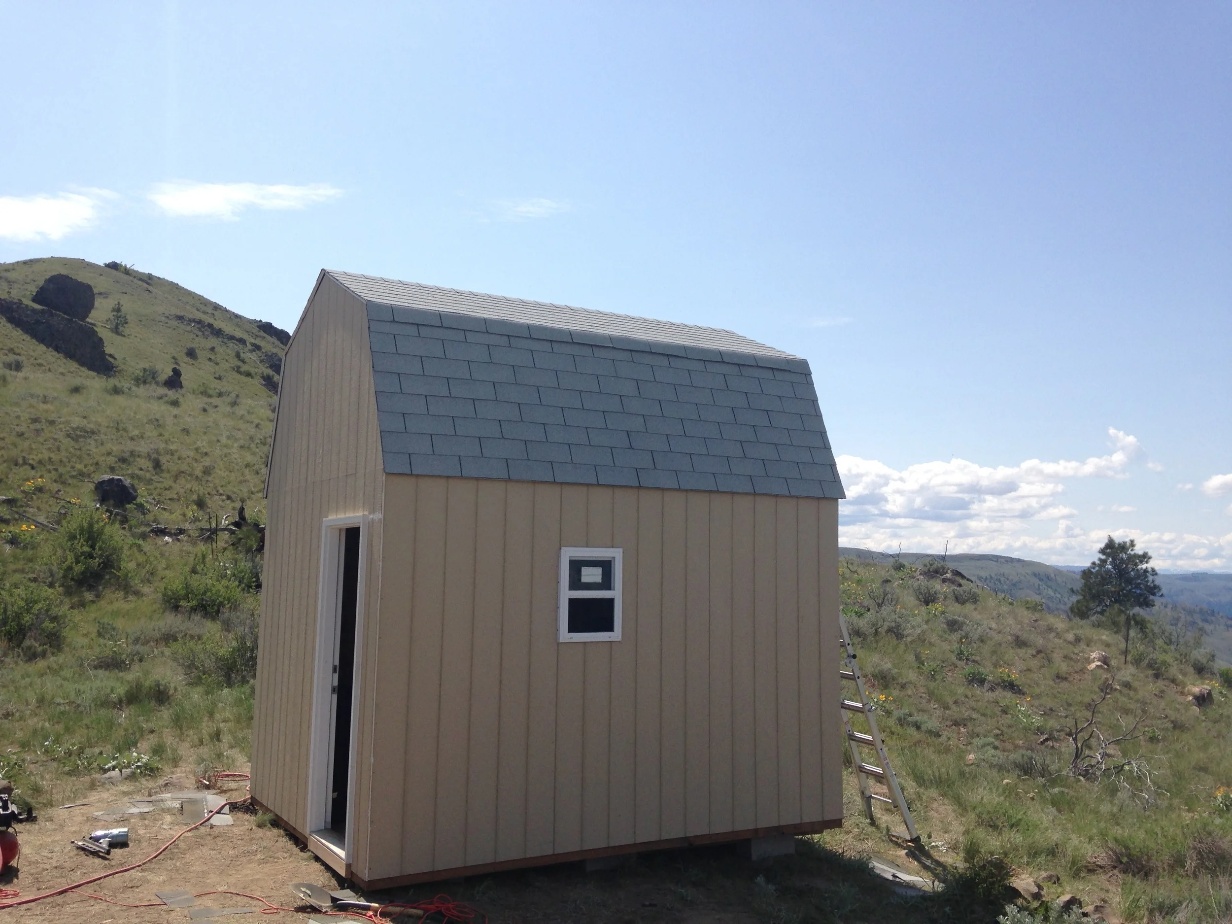 Shingled and ready to go! Most of the caulking was done, but we still need to add trim around the windows and paint the exterior. Next time!